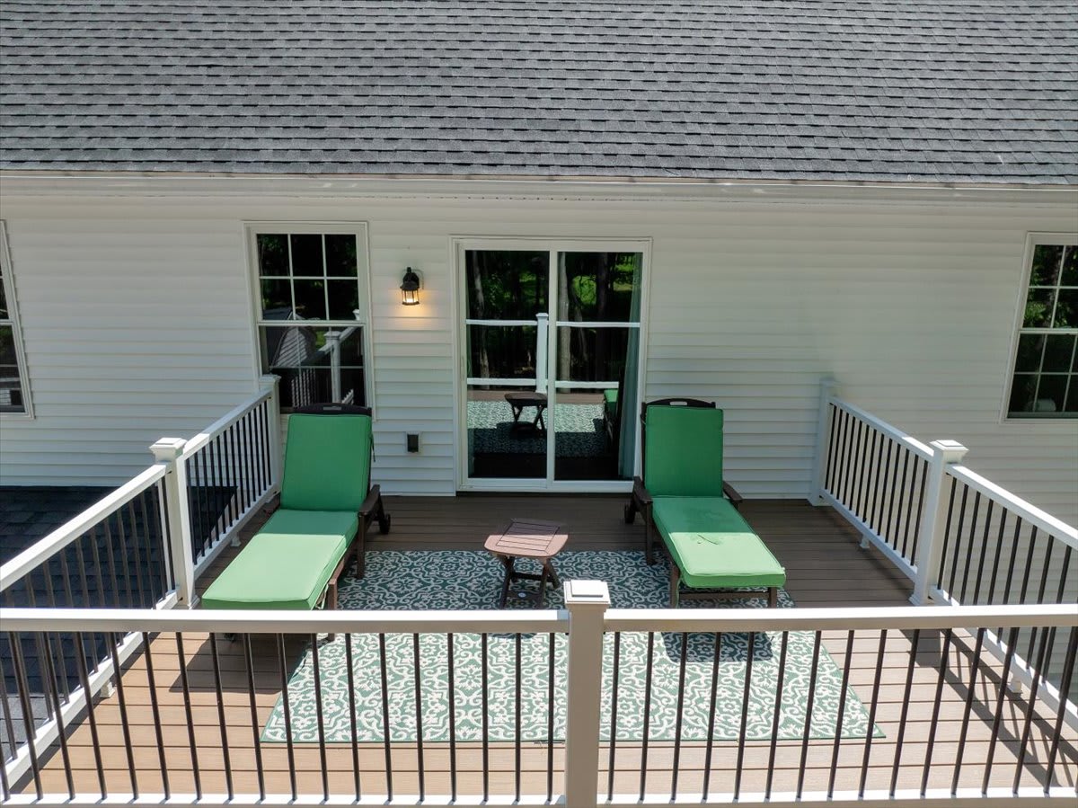 Aerial View of King Bedroom Showcasing Hardwood Floors and Natural Skylight