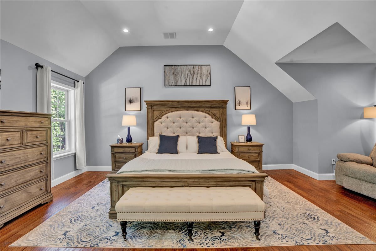Spacious King Bedroom with Vaulted Ceilings, Hardwood Floors, and Natural Light