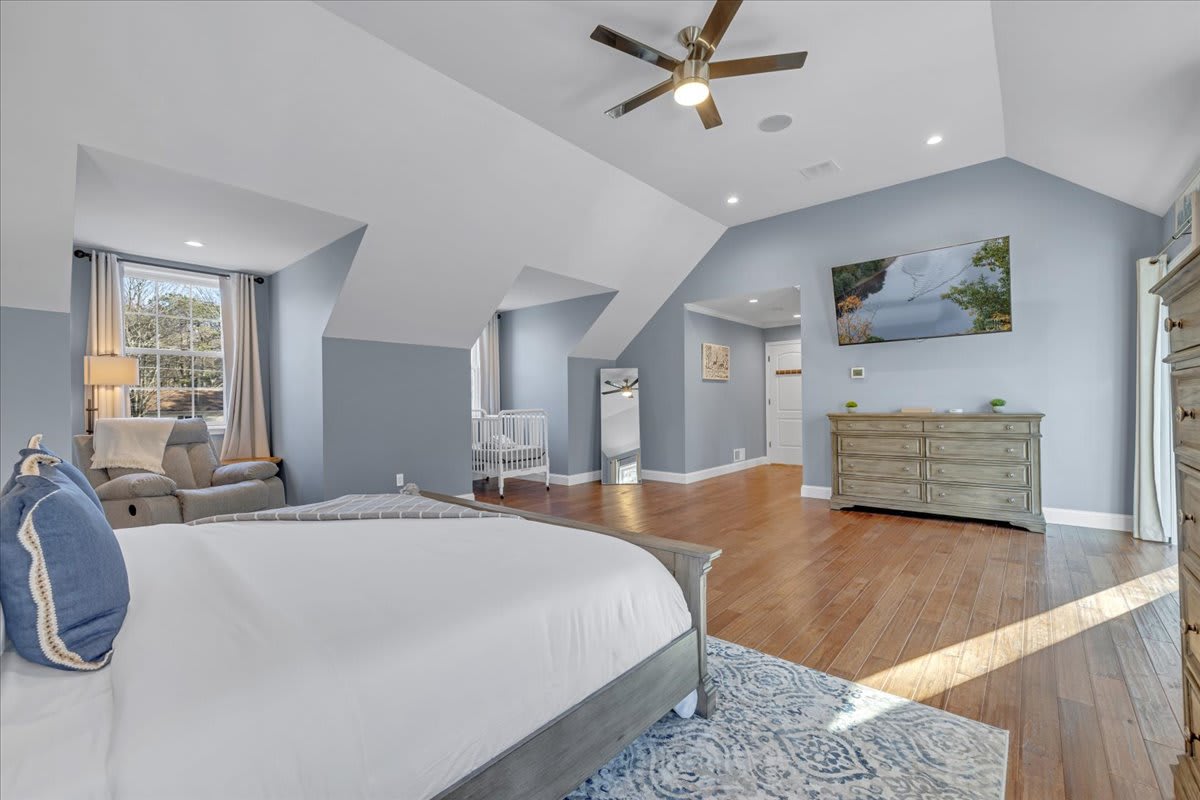 Comfortable King Bedroom with Ceiling Fan and Cozy White Bedding