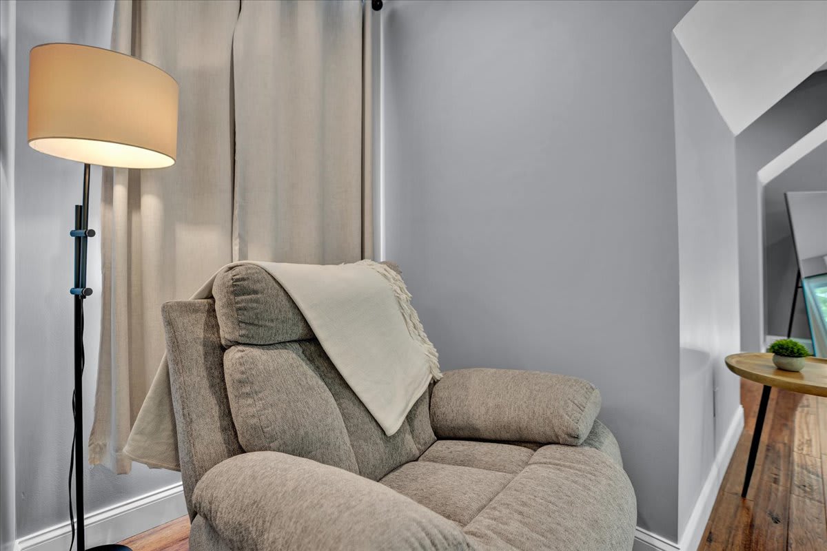 Cozy Reading Nook with Plush Armchair and Soft Floor Lamp Lighting