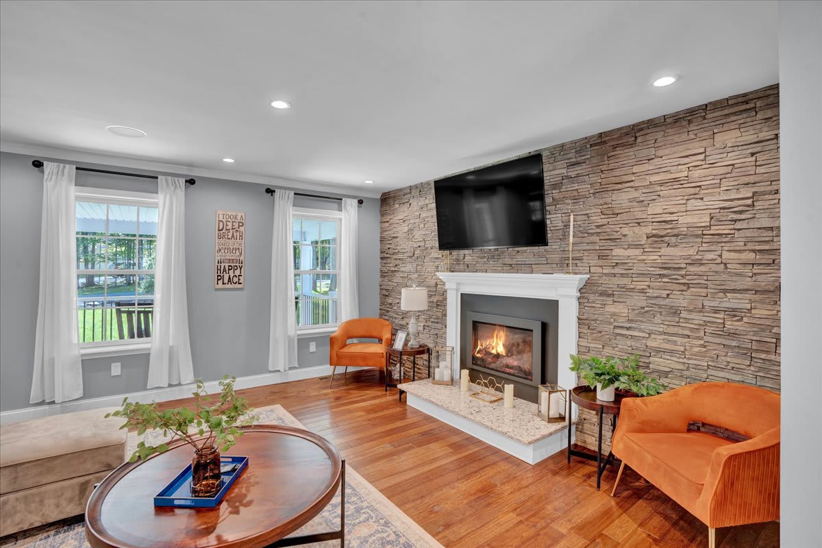 Rustic Living Room with Stone Fireplace and Hardwood Floors