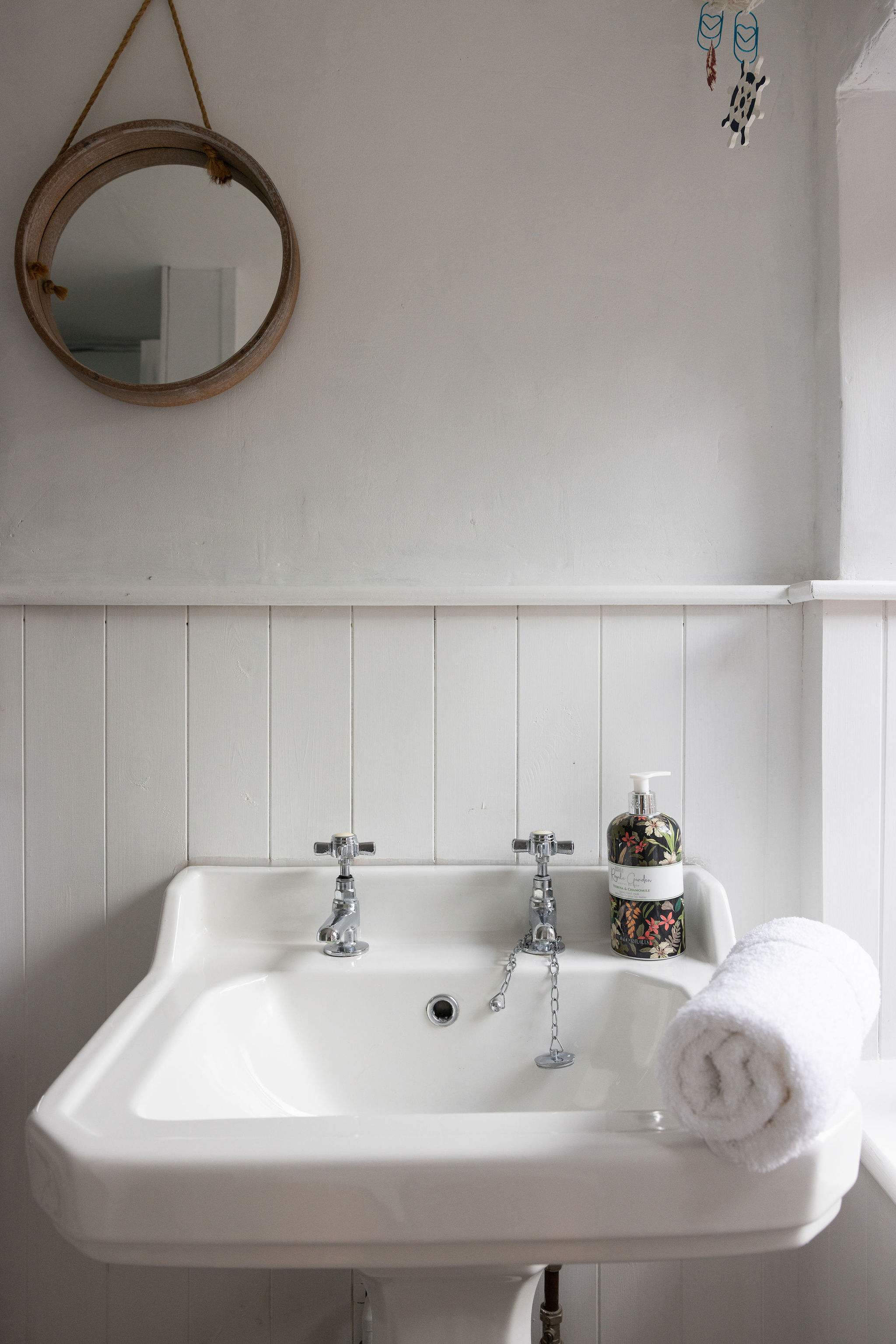 The bathroom is well stocked with towels and essential toiletries to freshen up after a day at the beach.