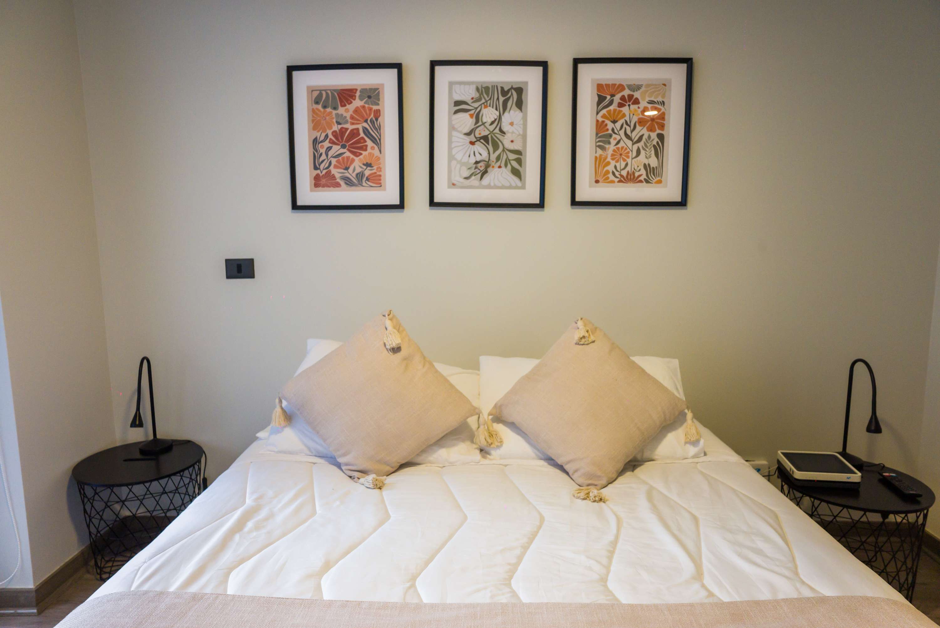 Cozy and stylish bedroom with elegant decor and modern lighting, perfect for a restful stay.