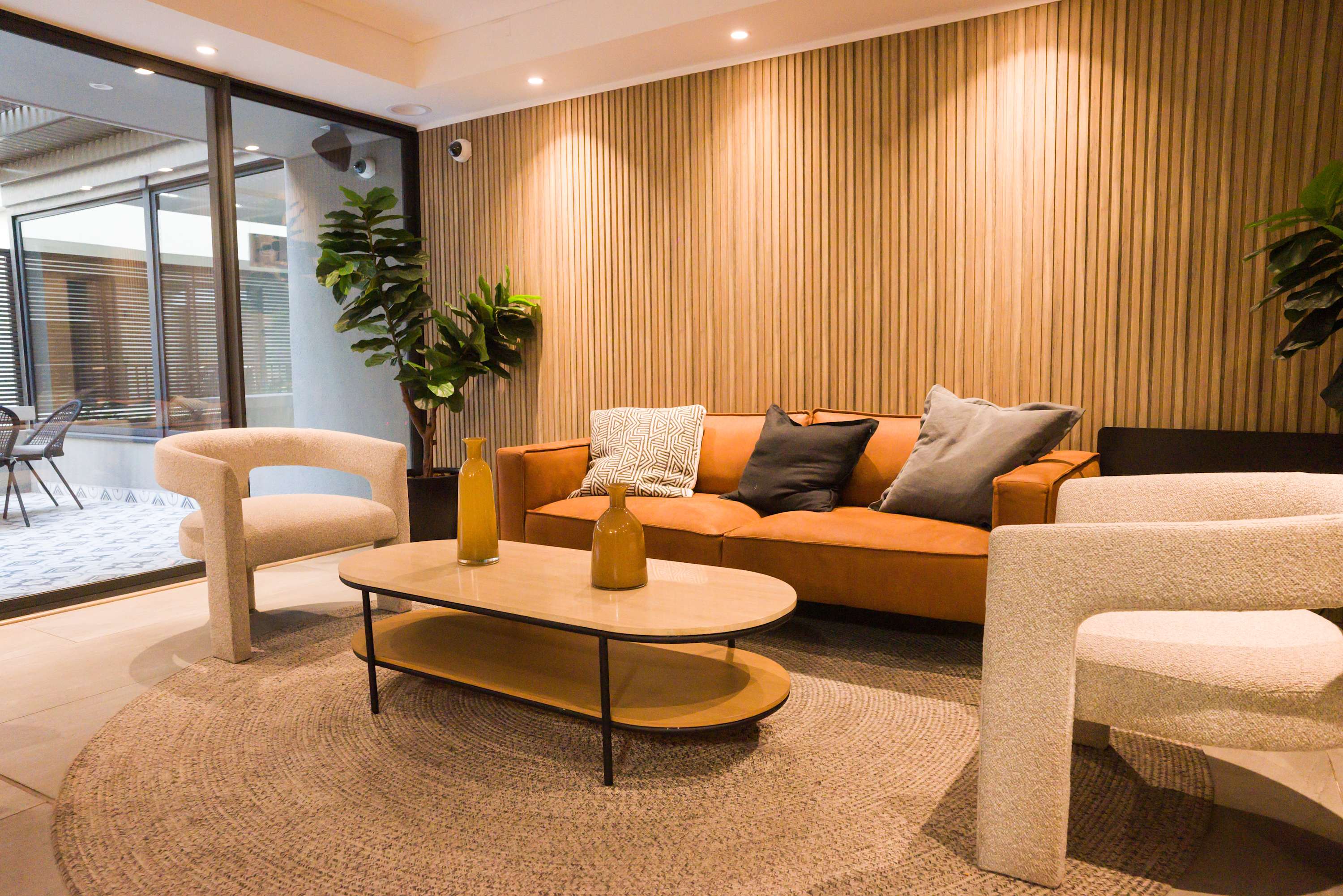 Relax in this stylish lounge area with cozy seating and a view of the outdoor patio, perfect for unwinding after a day of exploring.