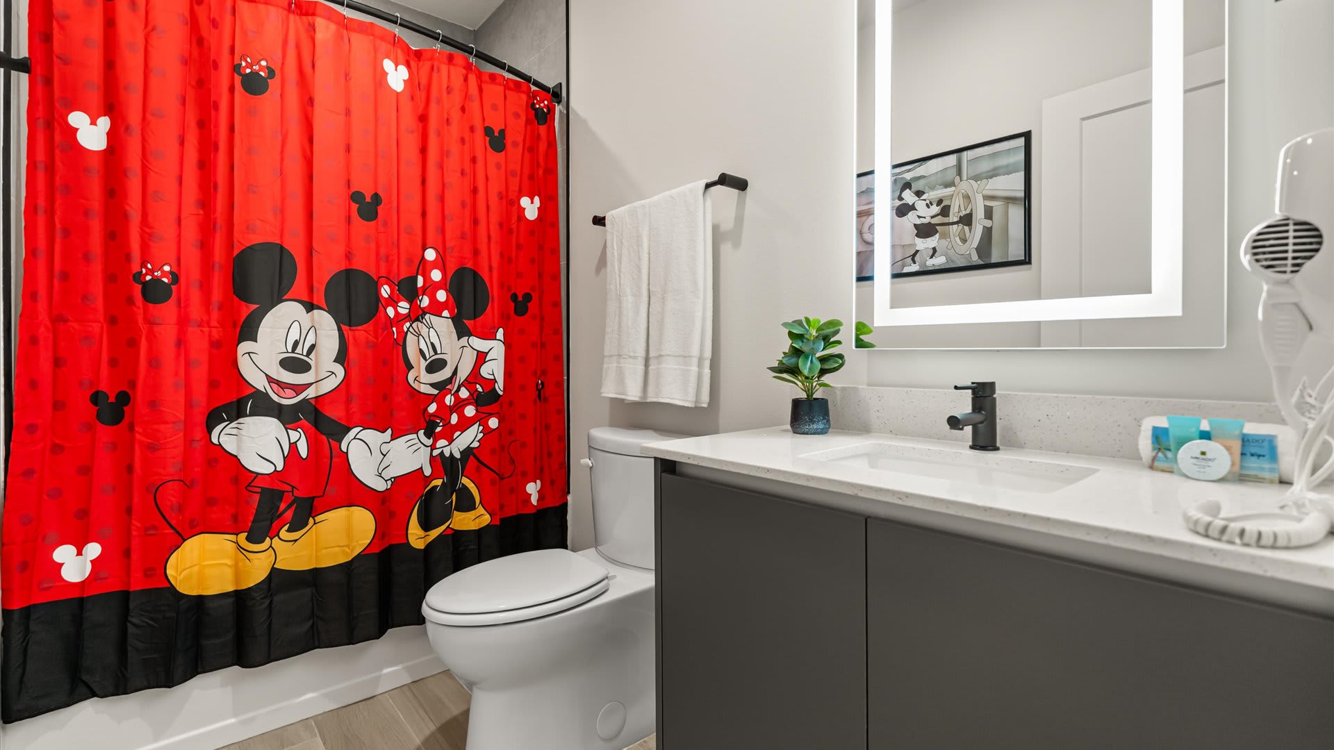 Mickey Moused Themed Full Bathroom with Combined Bathtub and Shower