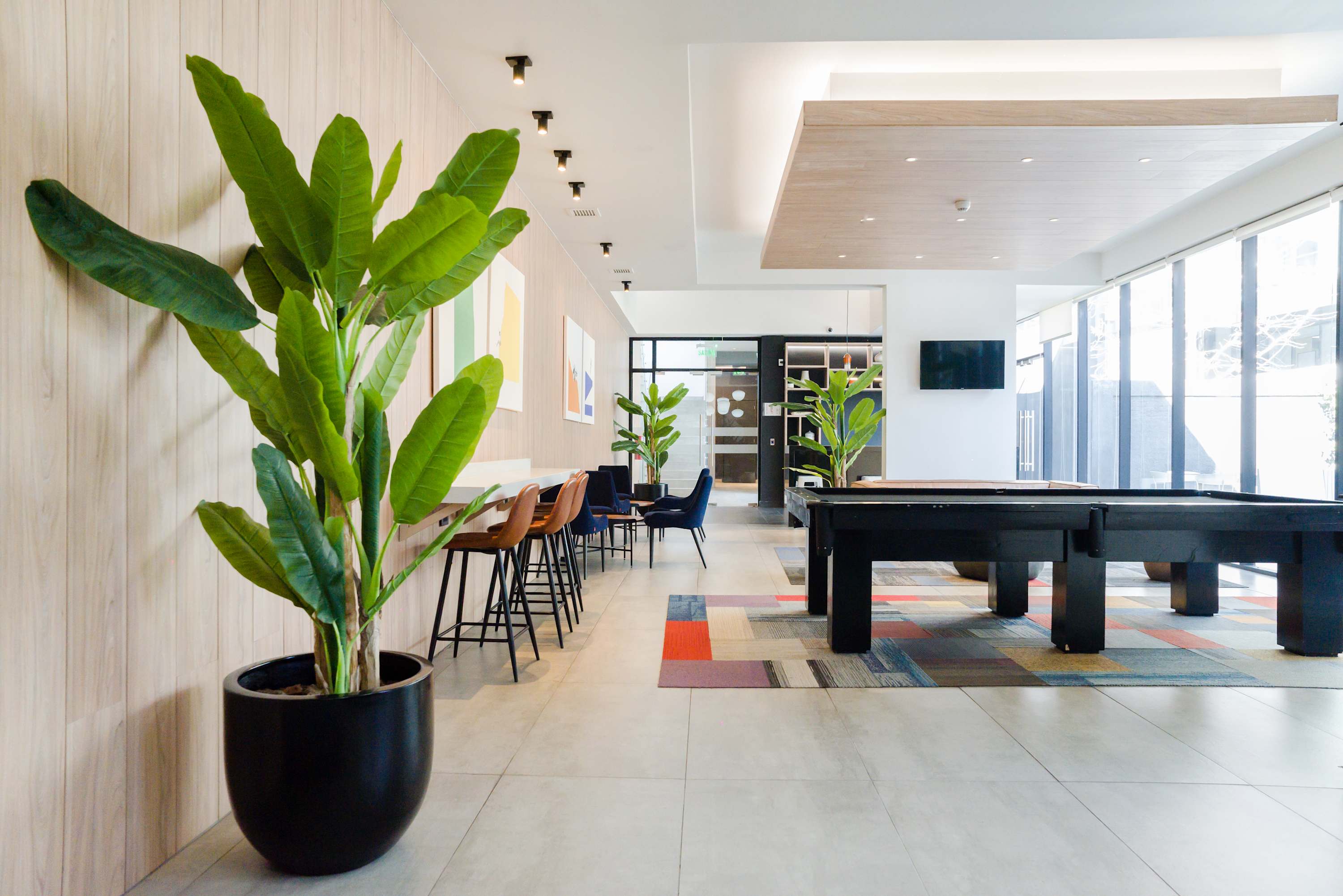 Relax and unwind in this stylish lounge with a pool table and vibrant decor, perfect for socializing or enjoying some downtime.