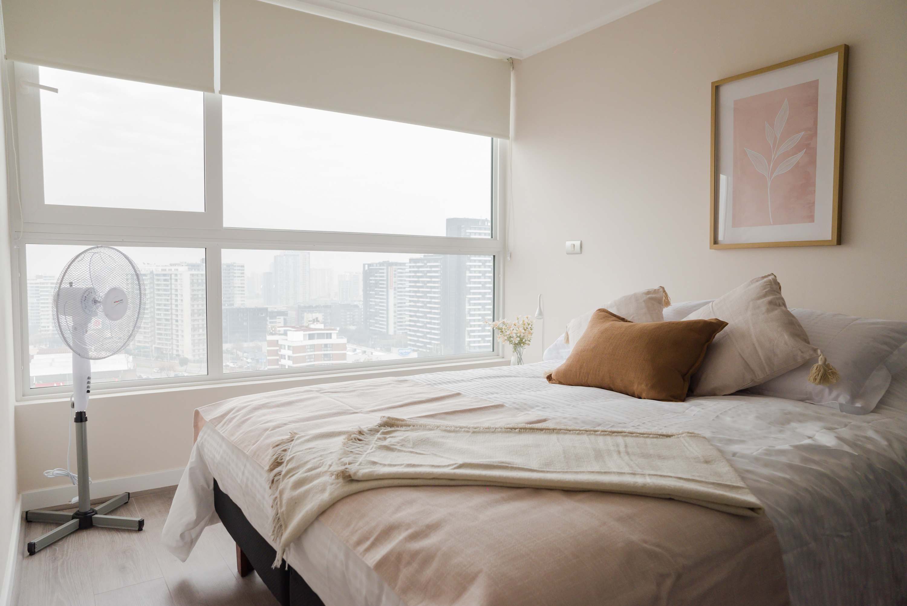 Relax in this cozy bedroom with stunning city views and soft natural light, perfect for unwinding after a day of exploring.