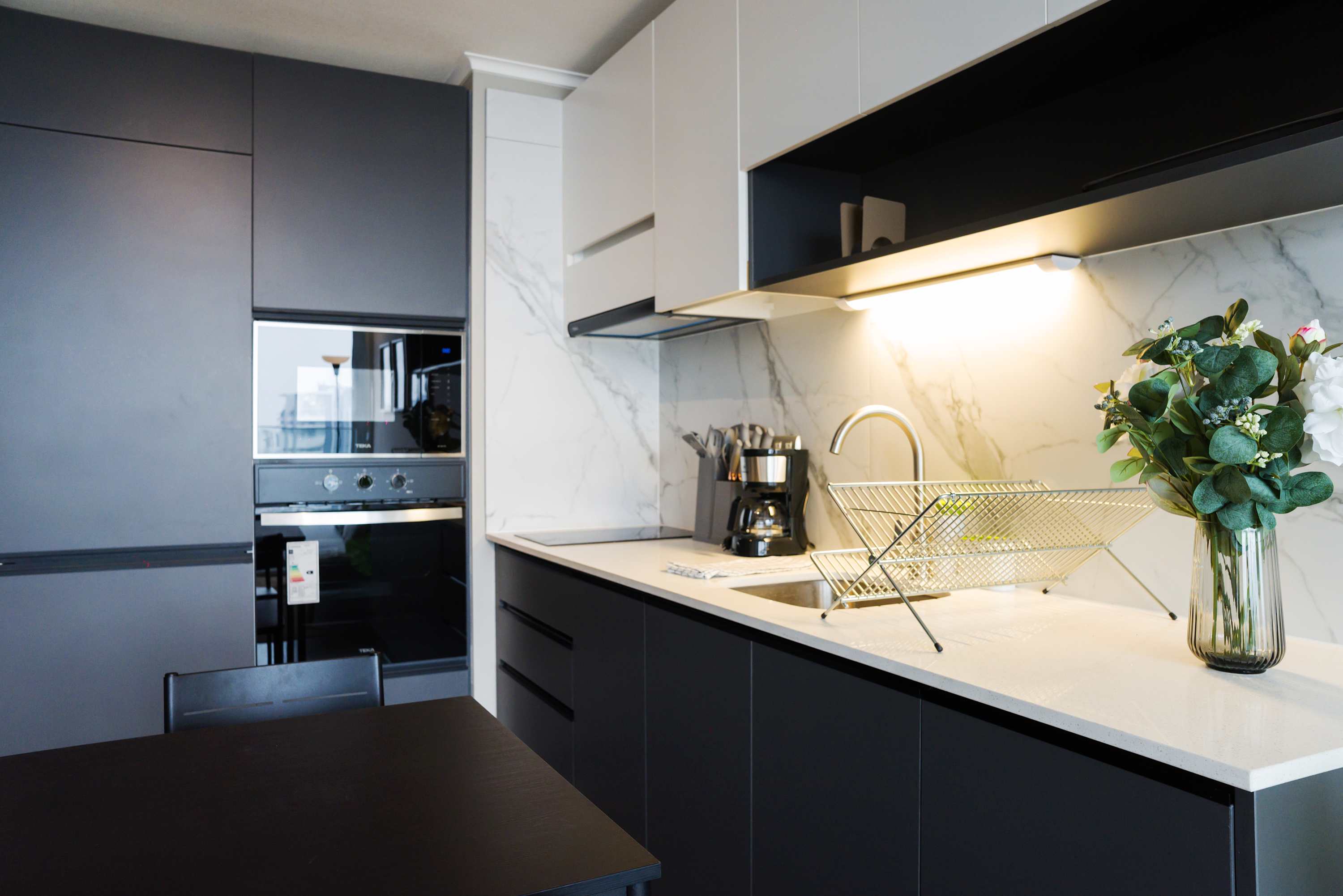 Sleek and modern kitchen with top-notch appliances and elegant design, perfect for culinary adventures.