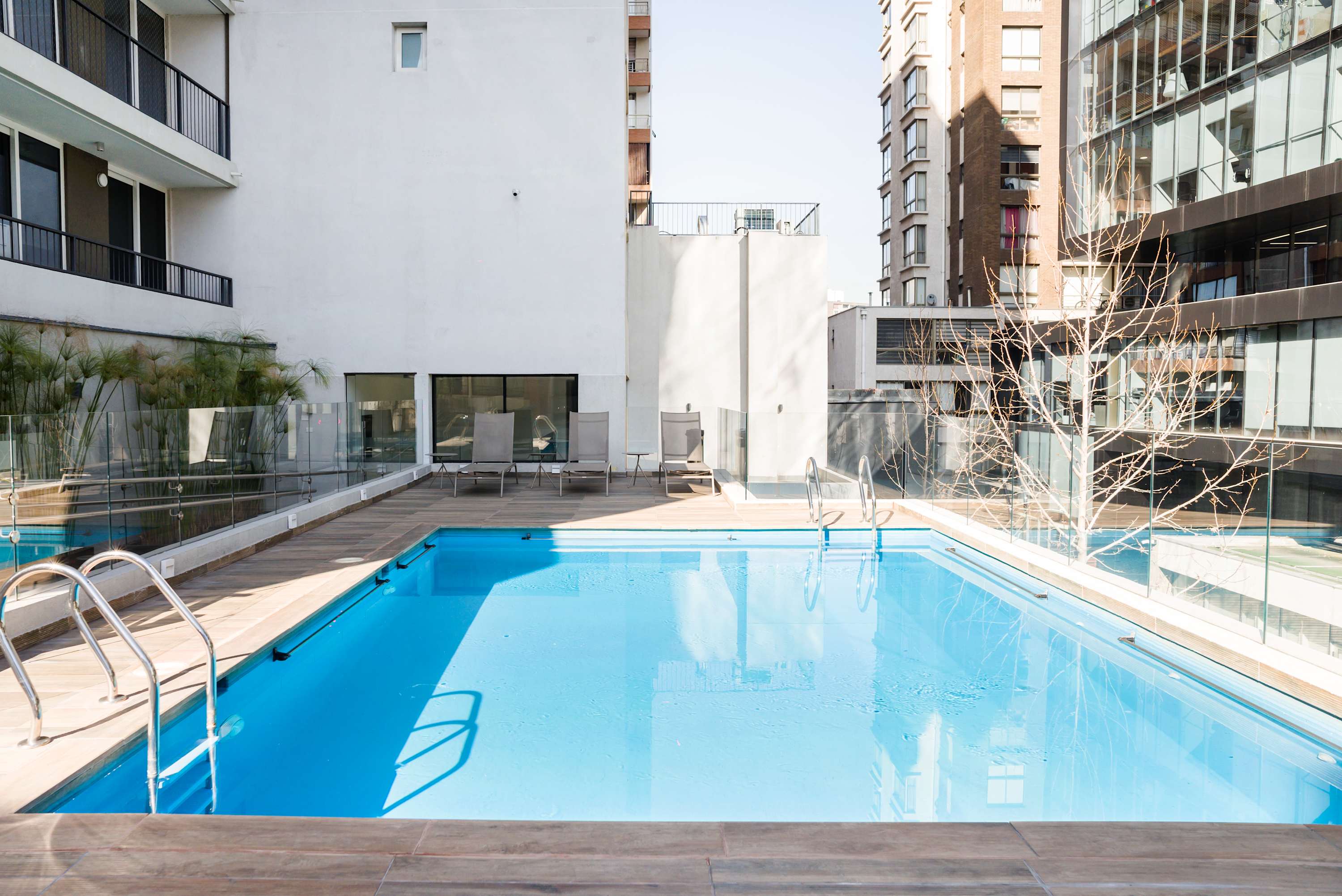 Relax and unwind by the pristine pool, perfect for a refreshing dip amidst the vibrant cityscape.