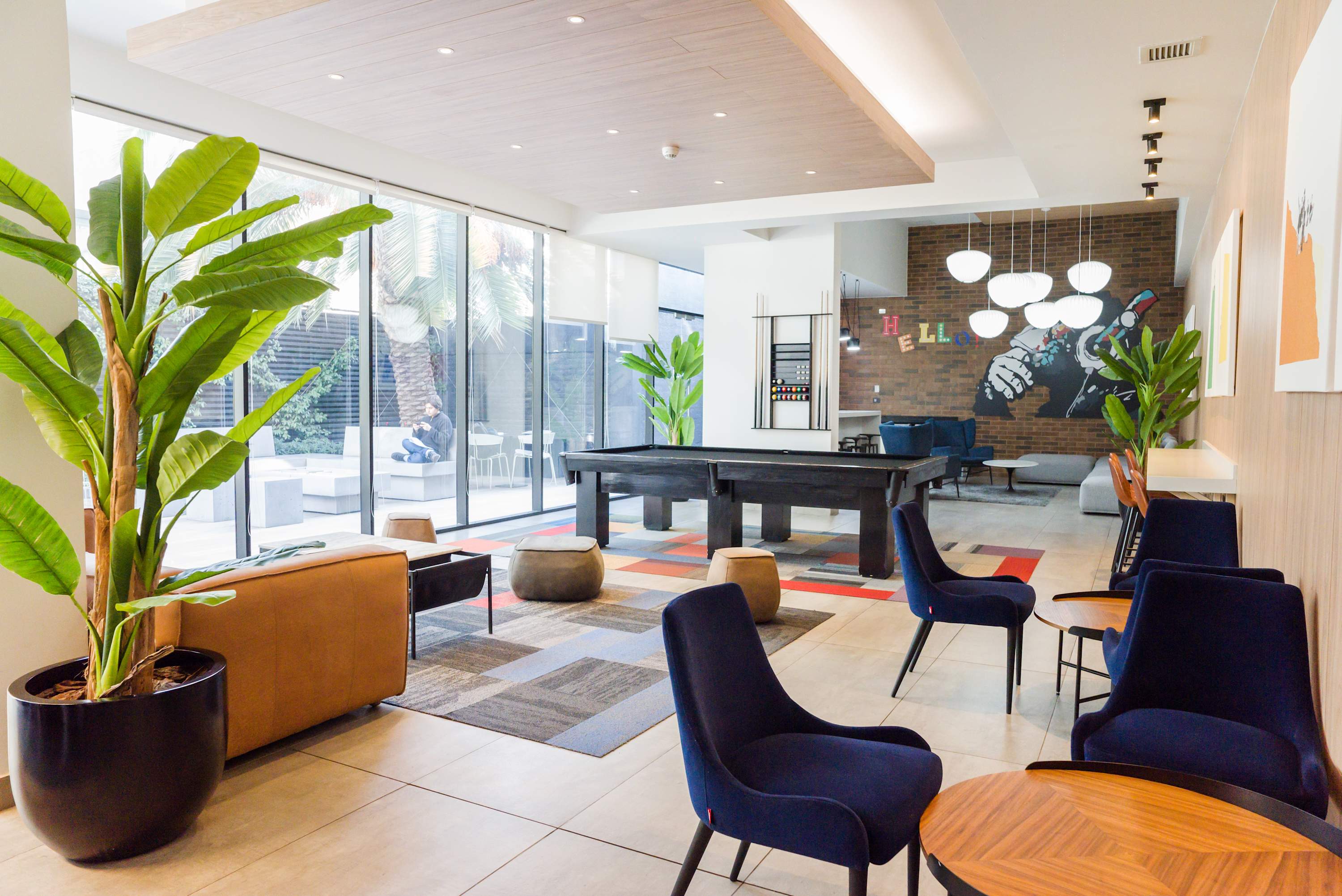 Enjoy a vibrant and stylish lounge area with a pool table and ample seating, perfect for relaxation and socializing.