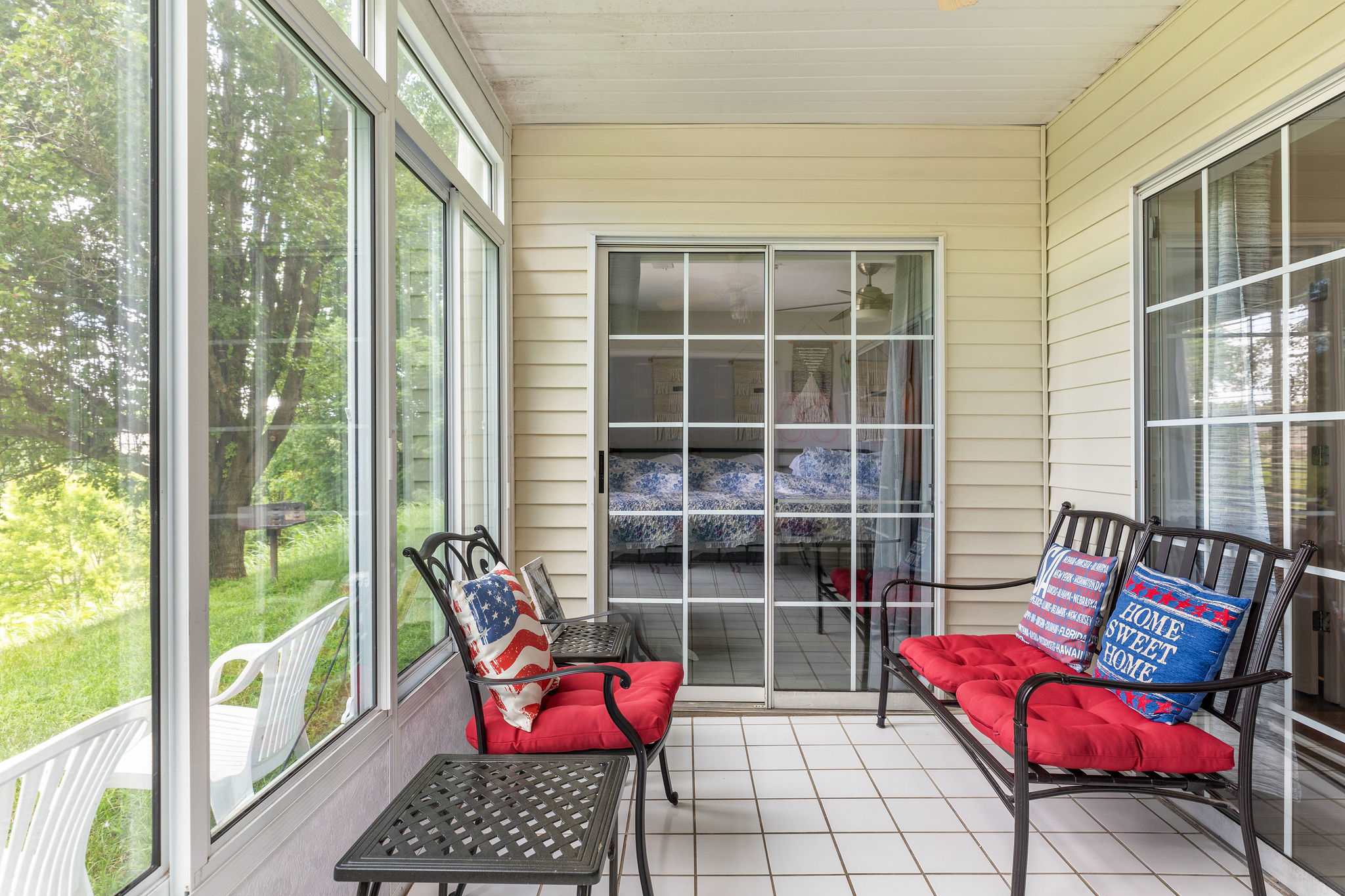 Enclosed patio overlooking the beautiful greenery - Community charcoal grill just outside