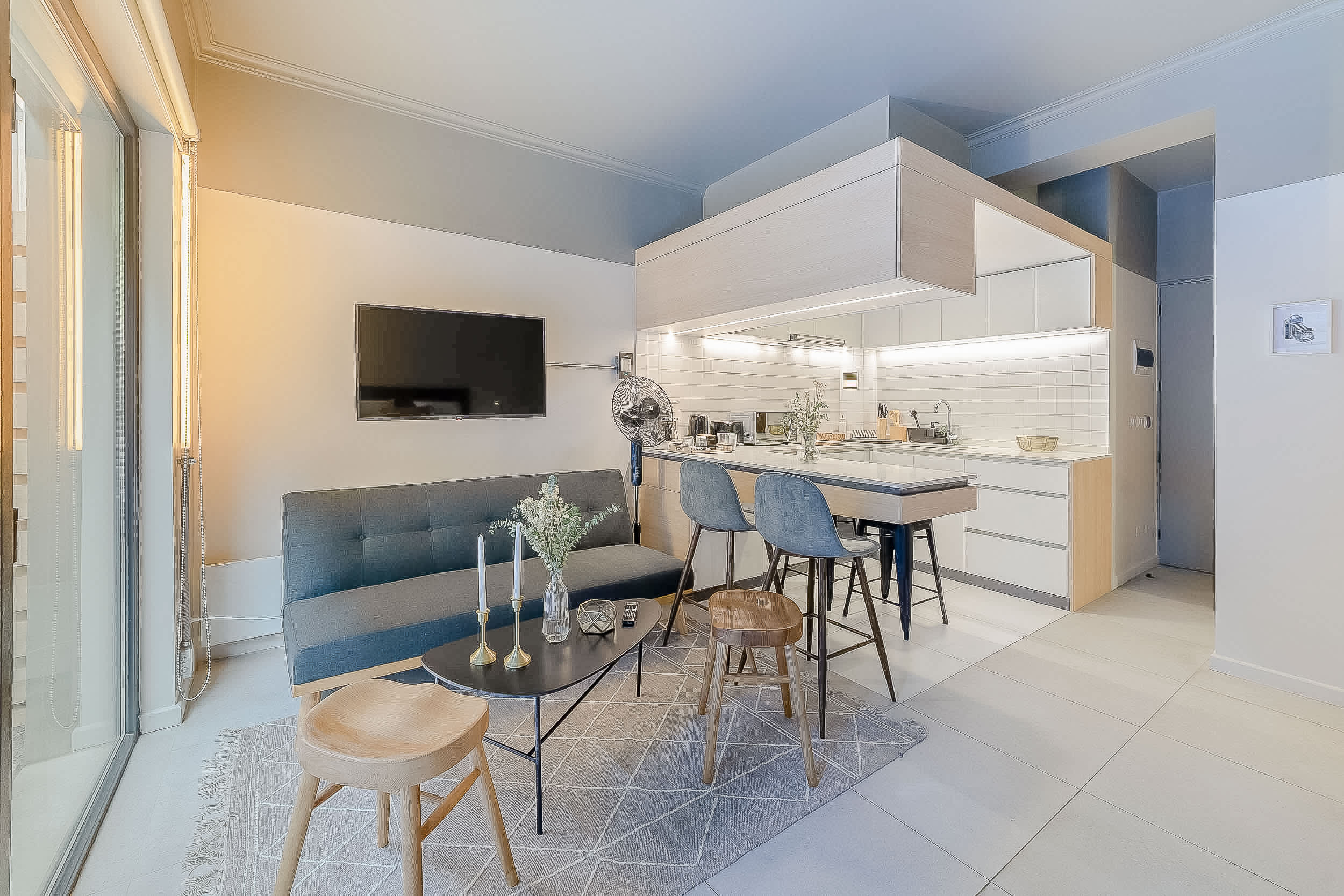 Experience modern comfort in this stylish studio with a cozy living area and sleek kitchen, perfect for a relaxing getaway.