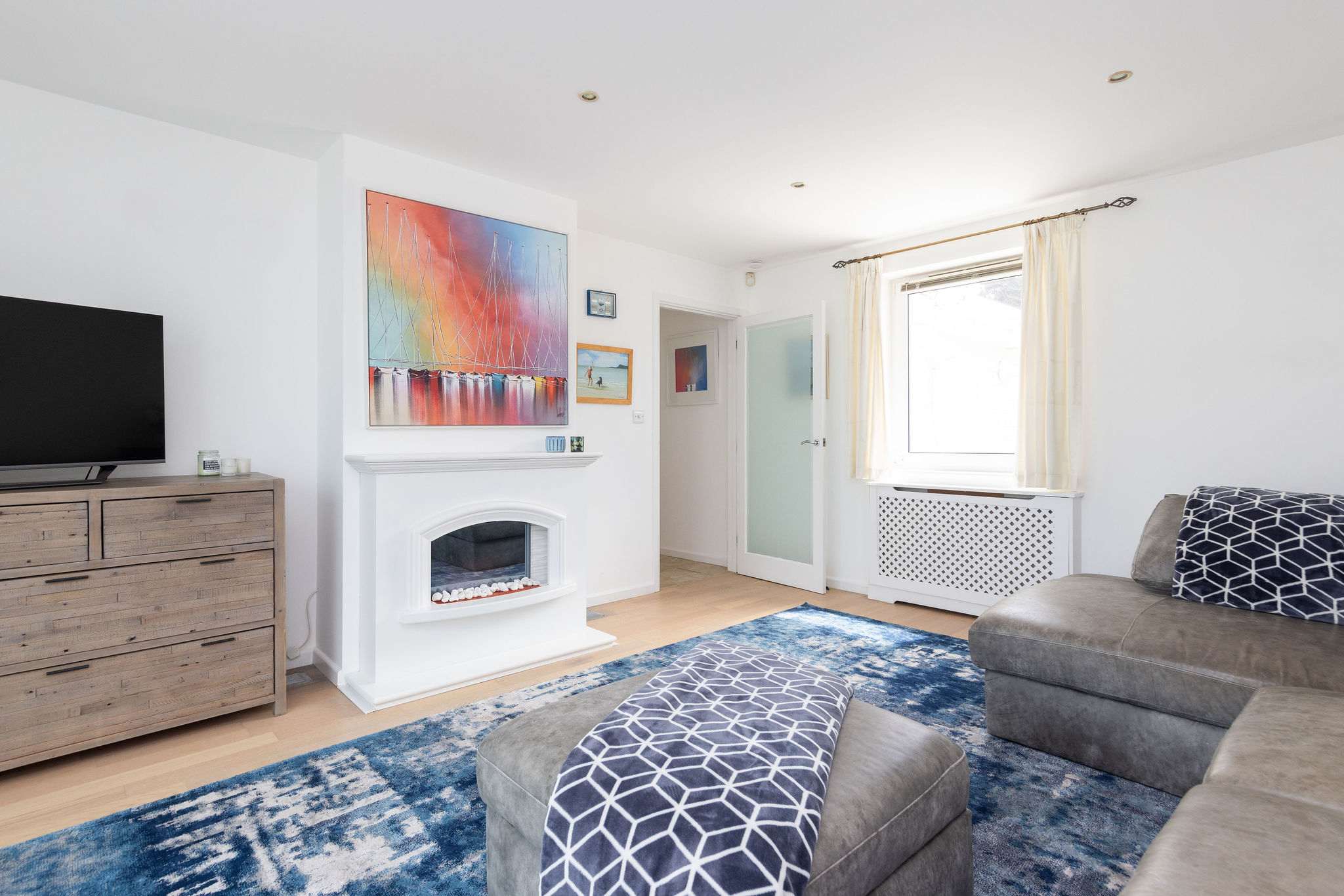 Cosy living room with stylish decor and electric fire