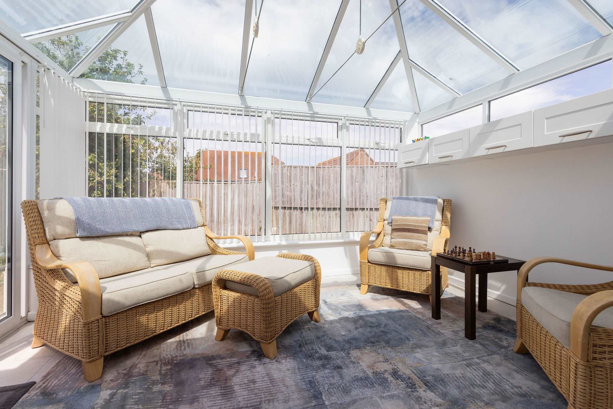 Sunny conservatory with comfy seating for 4