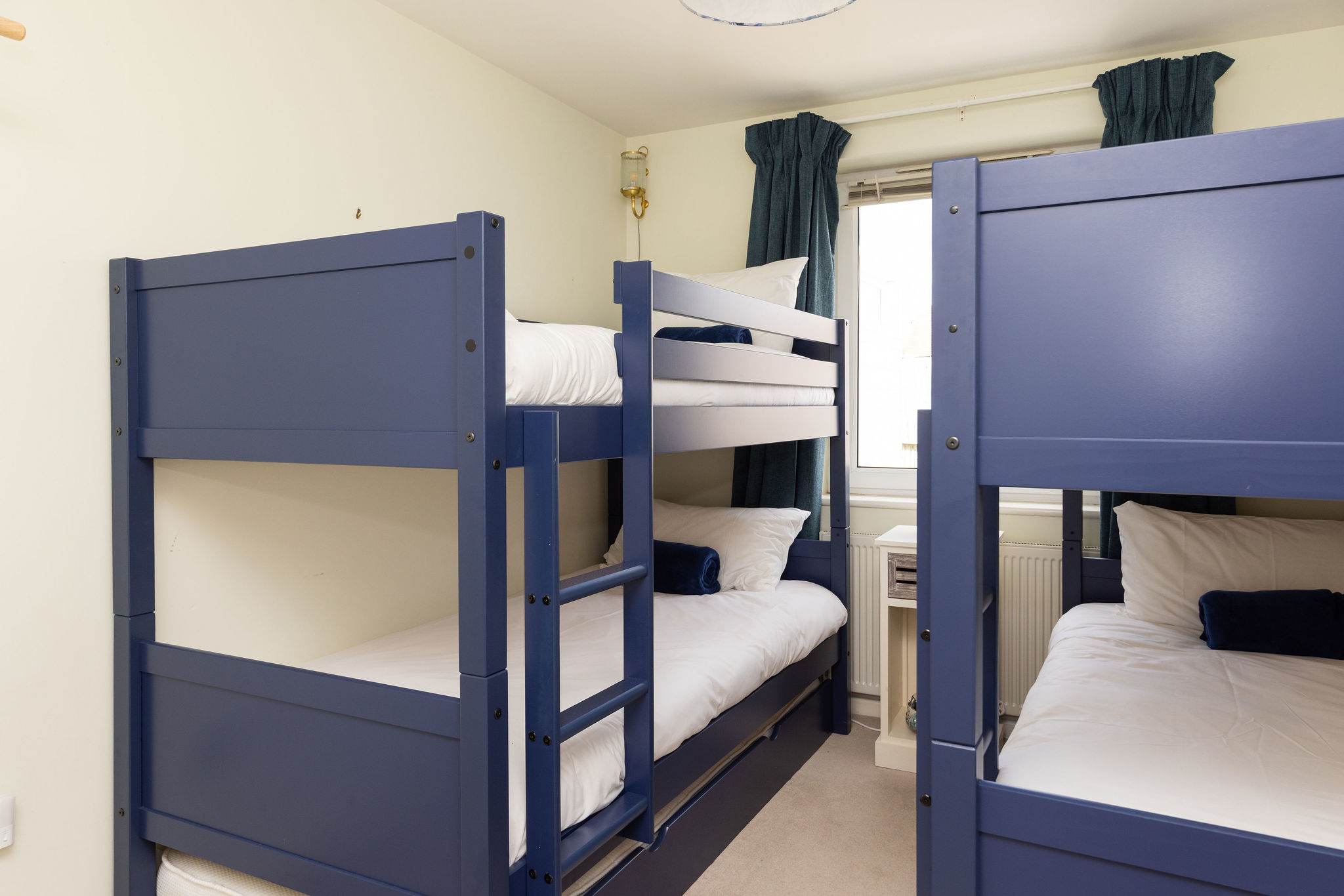 Bunk room with two sets of sturdy wooden bunks