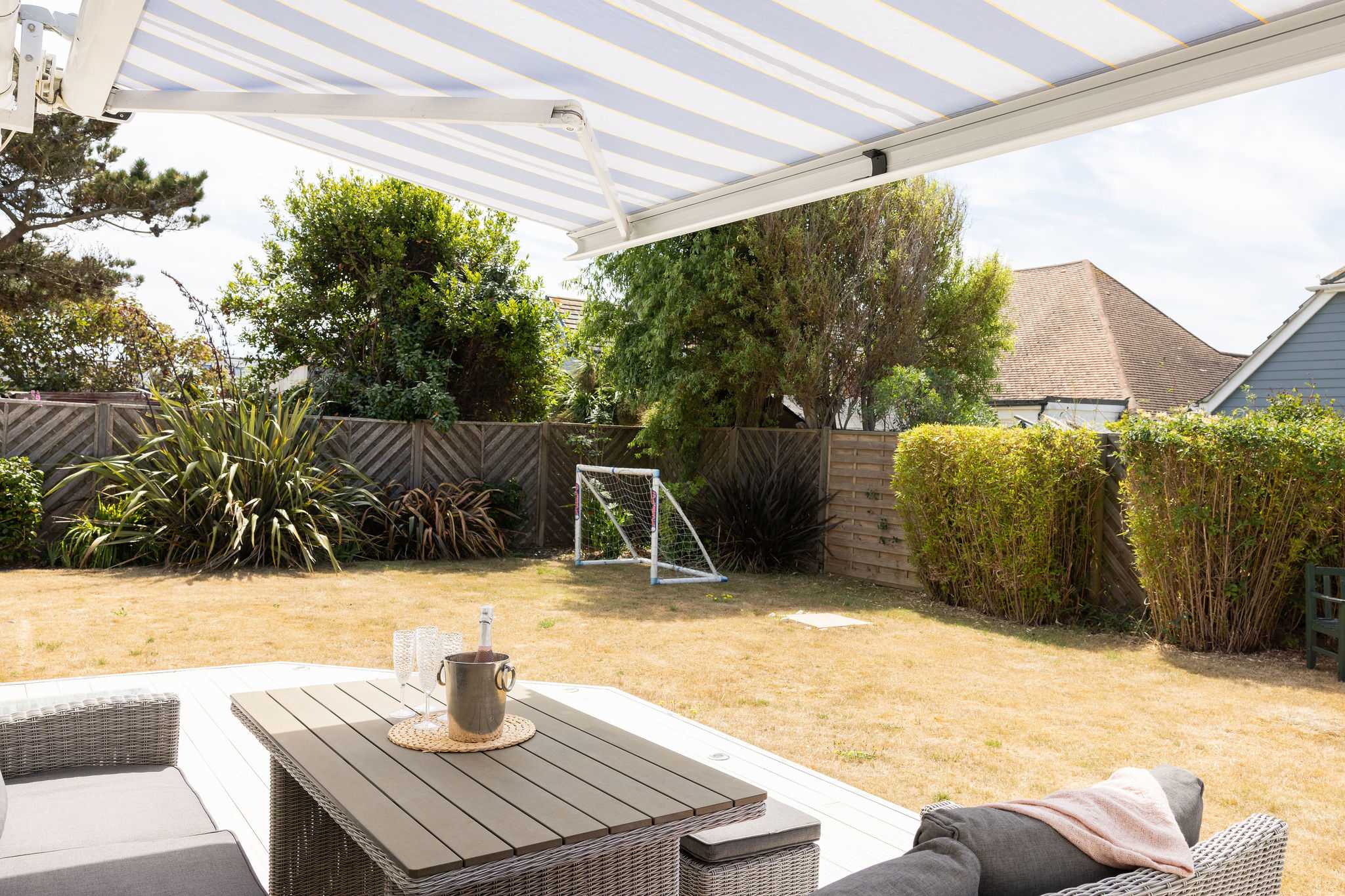 Relax in the shade under the awning with garden views and a couple of goals for the kids