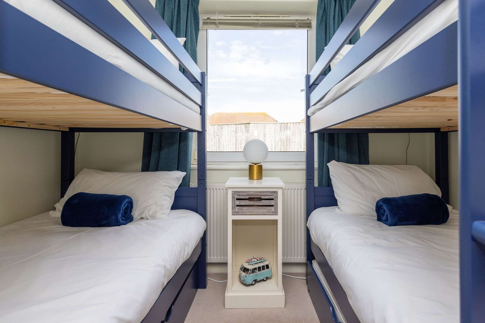 Bright and cosy room with two sets of bunk beds, ideal for kids or friends