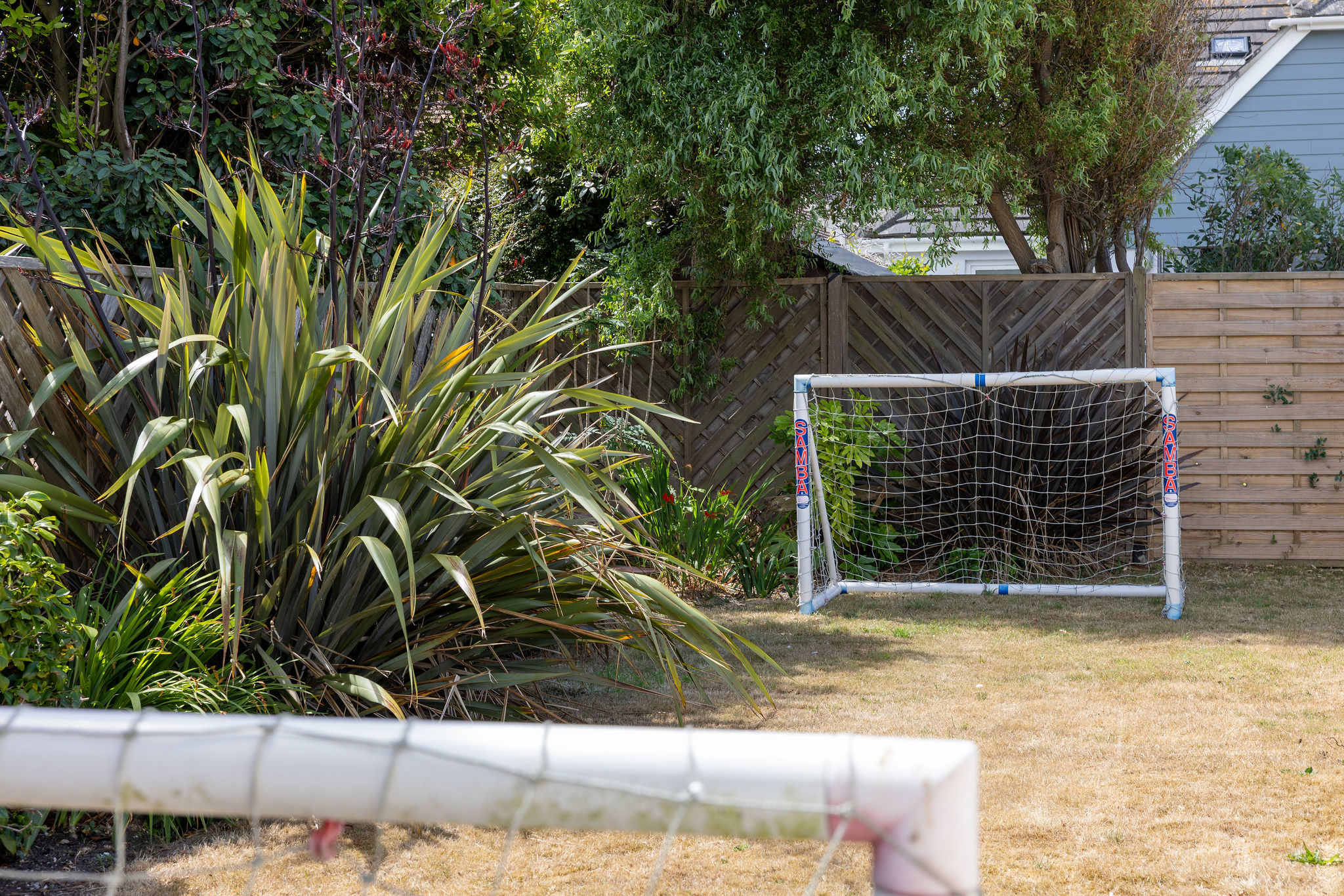 Private garden with mini football goals for kids to play