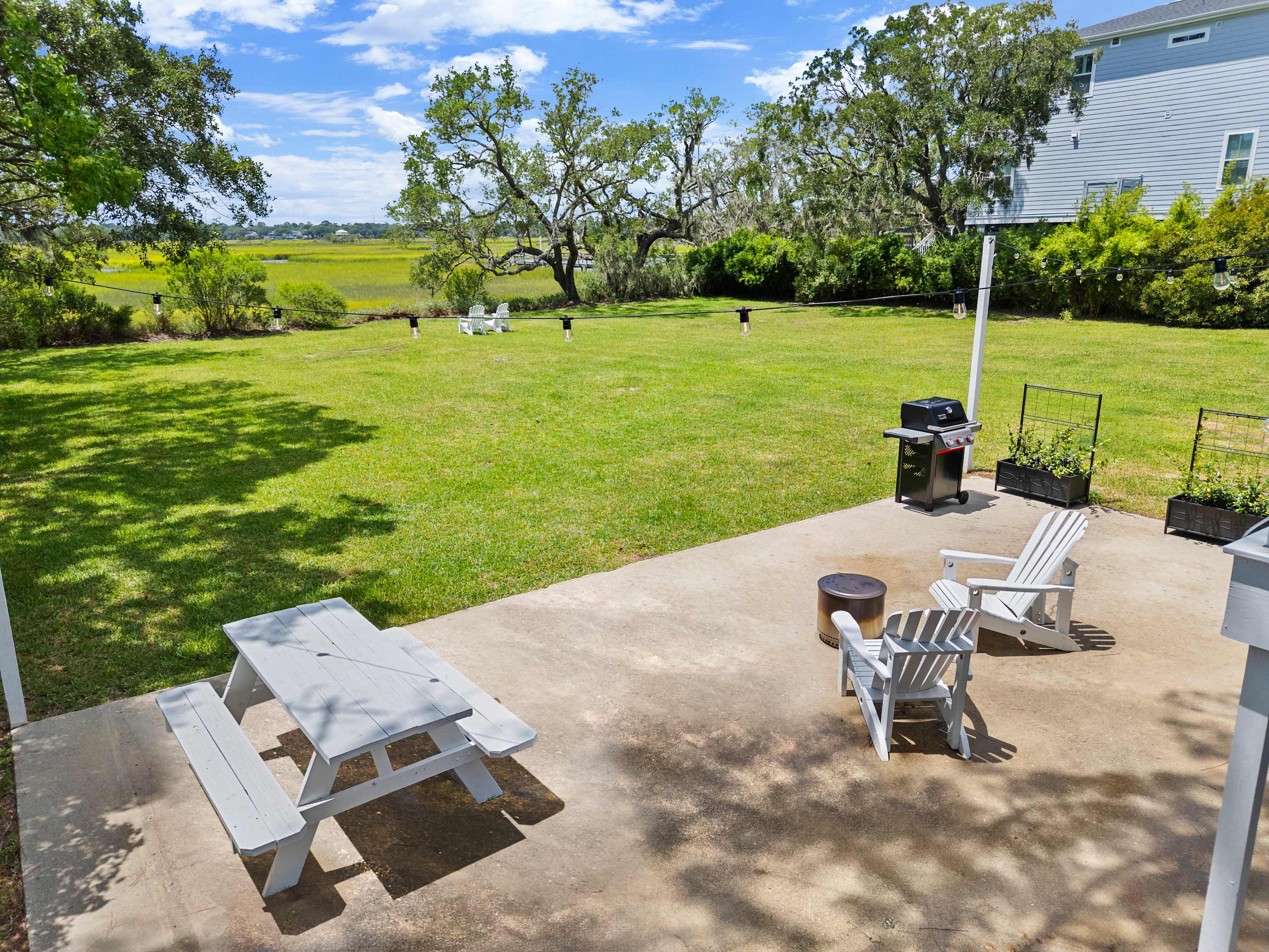 Backyard views with seating and a grill for your group 