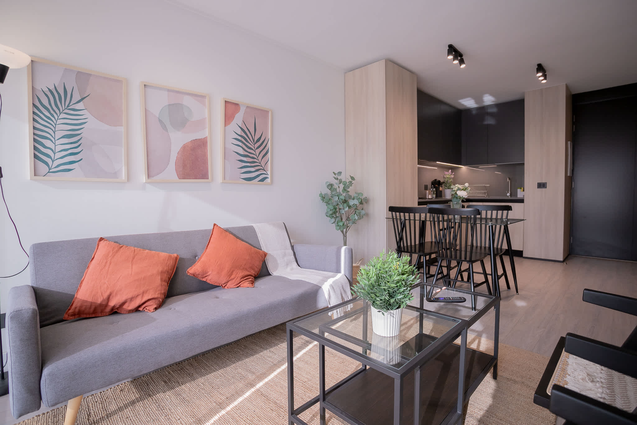 Chic and cozy living space with modern decor and a fully equipped kitchen, perfect for a relaxing stay.