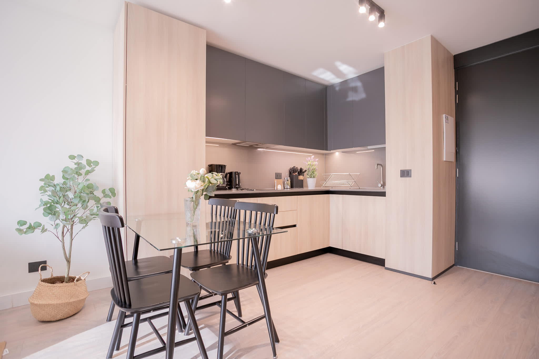 Sleek, modern kitchen with ample natural light and stylish dining area, perfect for cozy meals.