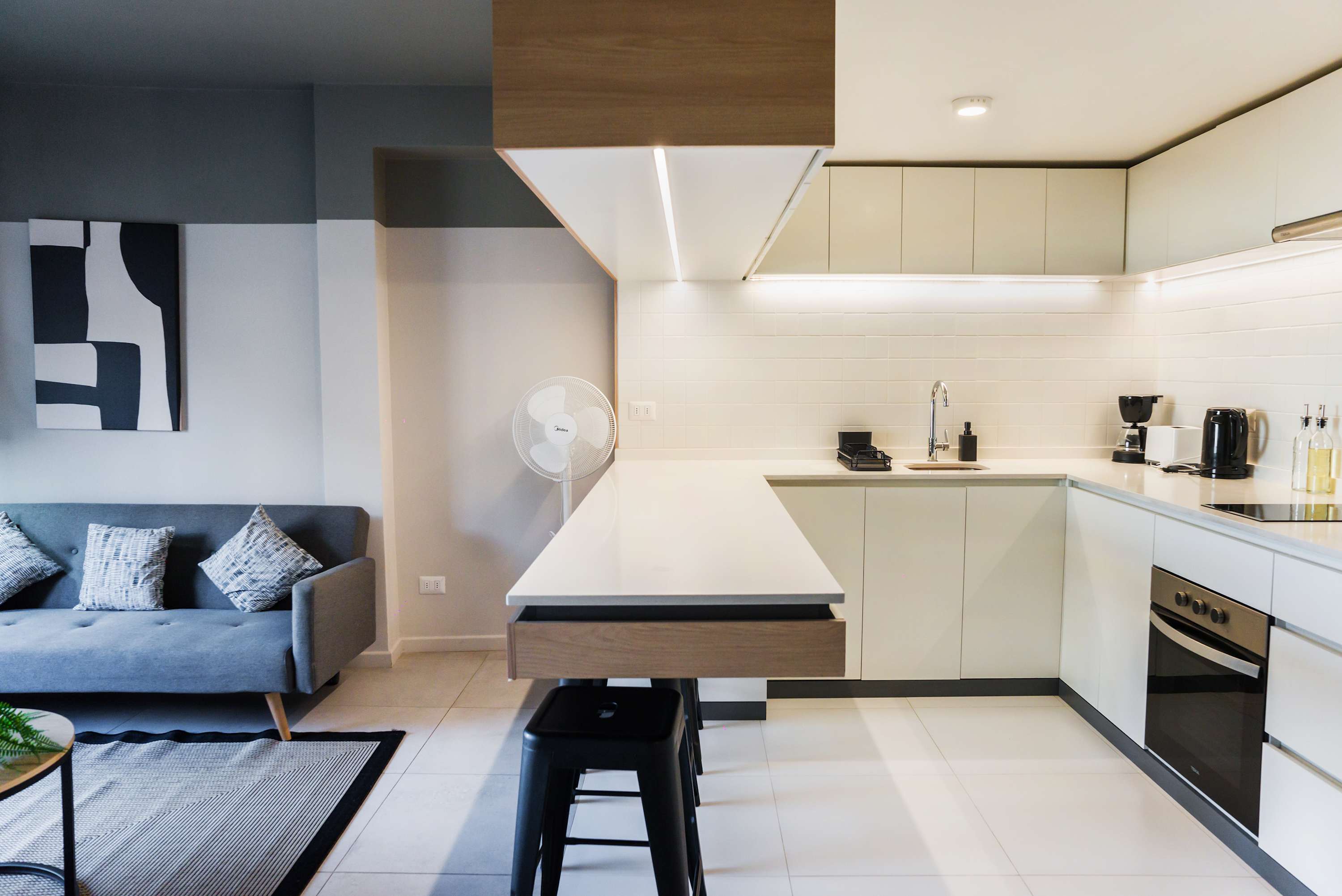 Experience modern living in this stylish studio with a sleek kitchen and cozy lounge area, perfect for your stay in Chile.