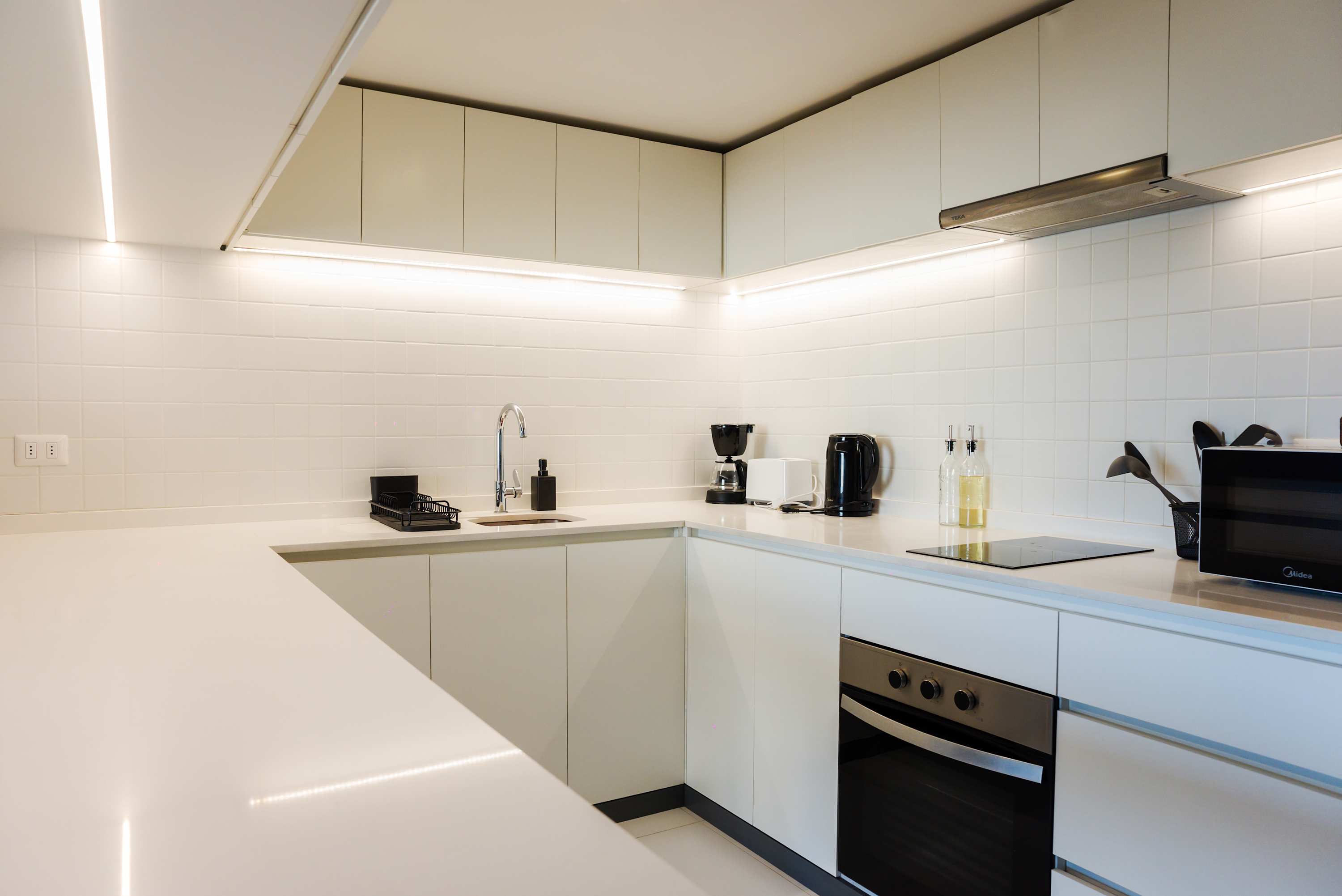 Sleek and modern kitchen with top-notch appliances, perfect for cooking your favorite meals in style.