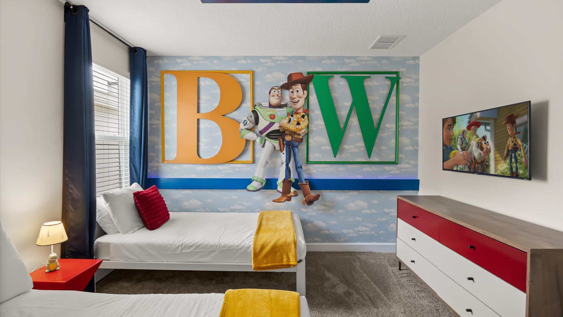 Toy Story-themed bedroom with 1 double bed and 1 single bed and smart TV
