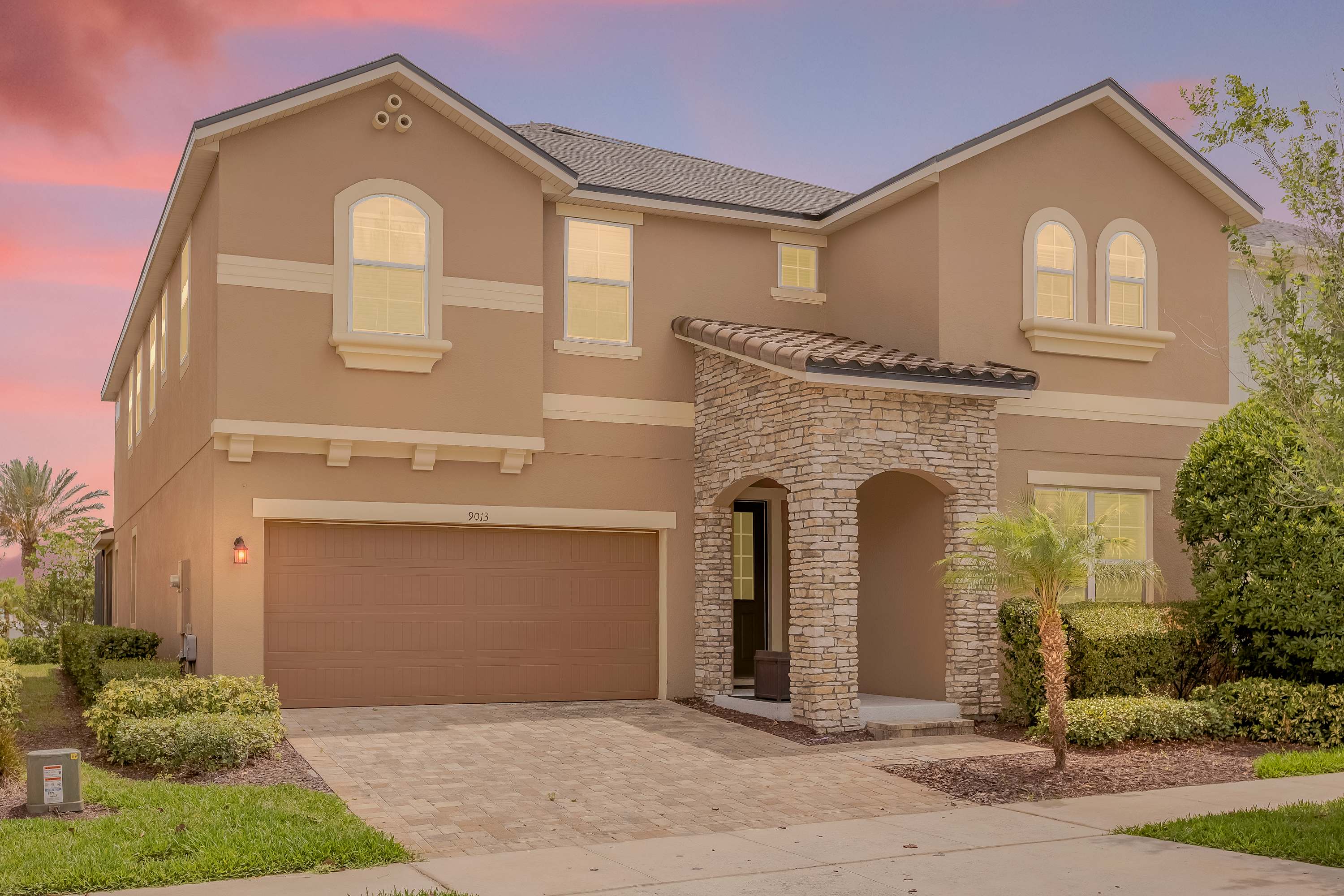 Experience luxury in this stunning villa with a charming stone facade and lush garden, perfect for a relaxing getaway.