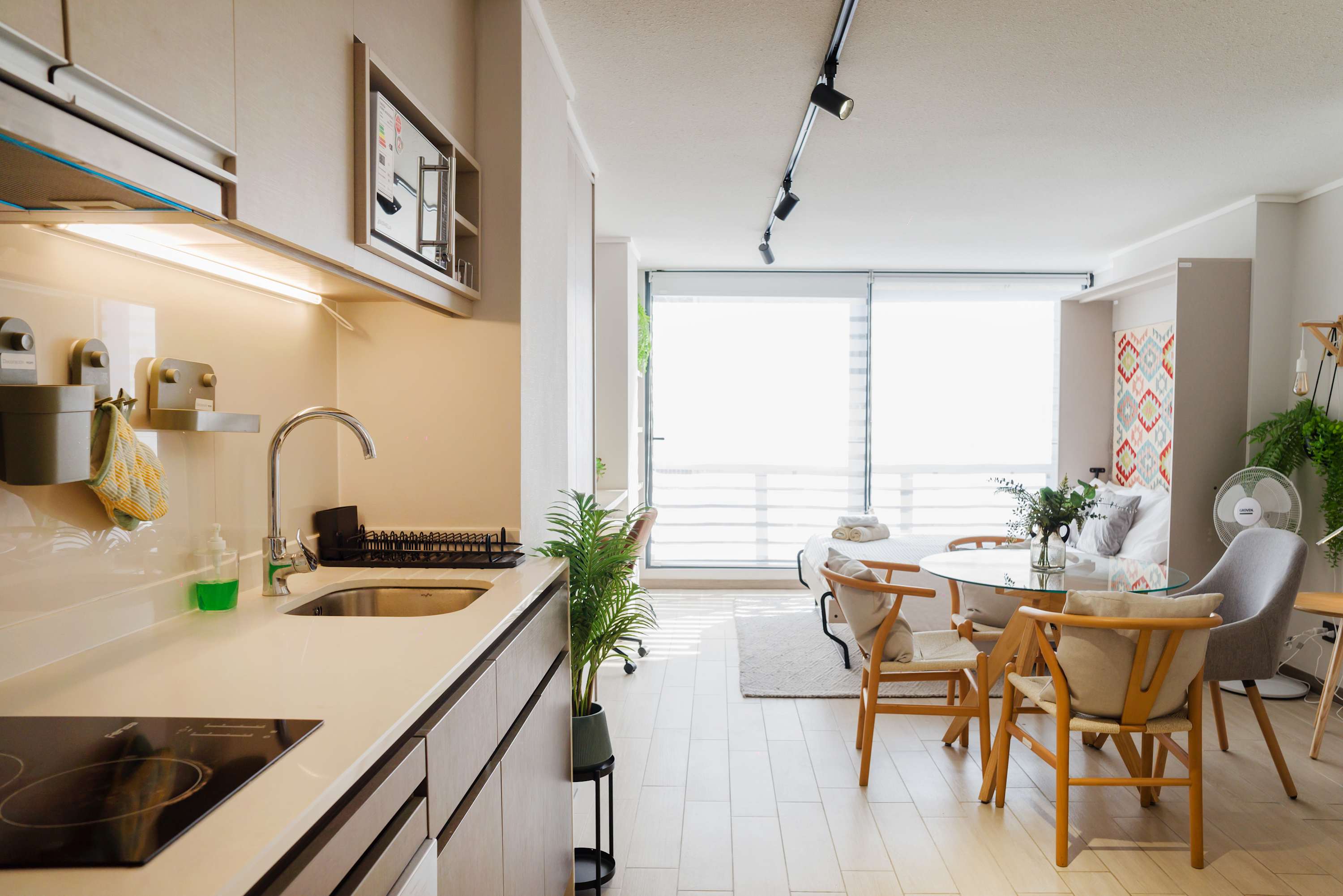 Experience modern living in this bright studio with a sleek kitchenette and cozy dining area, perfect for relaxation.