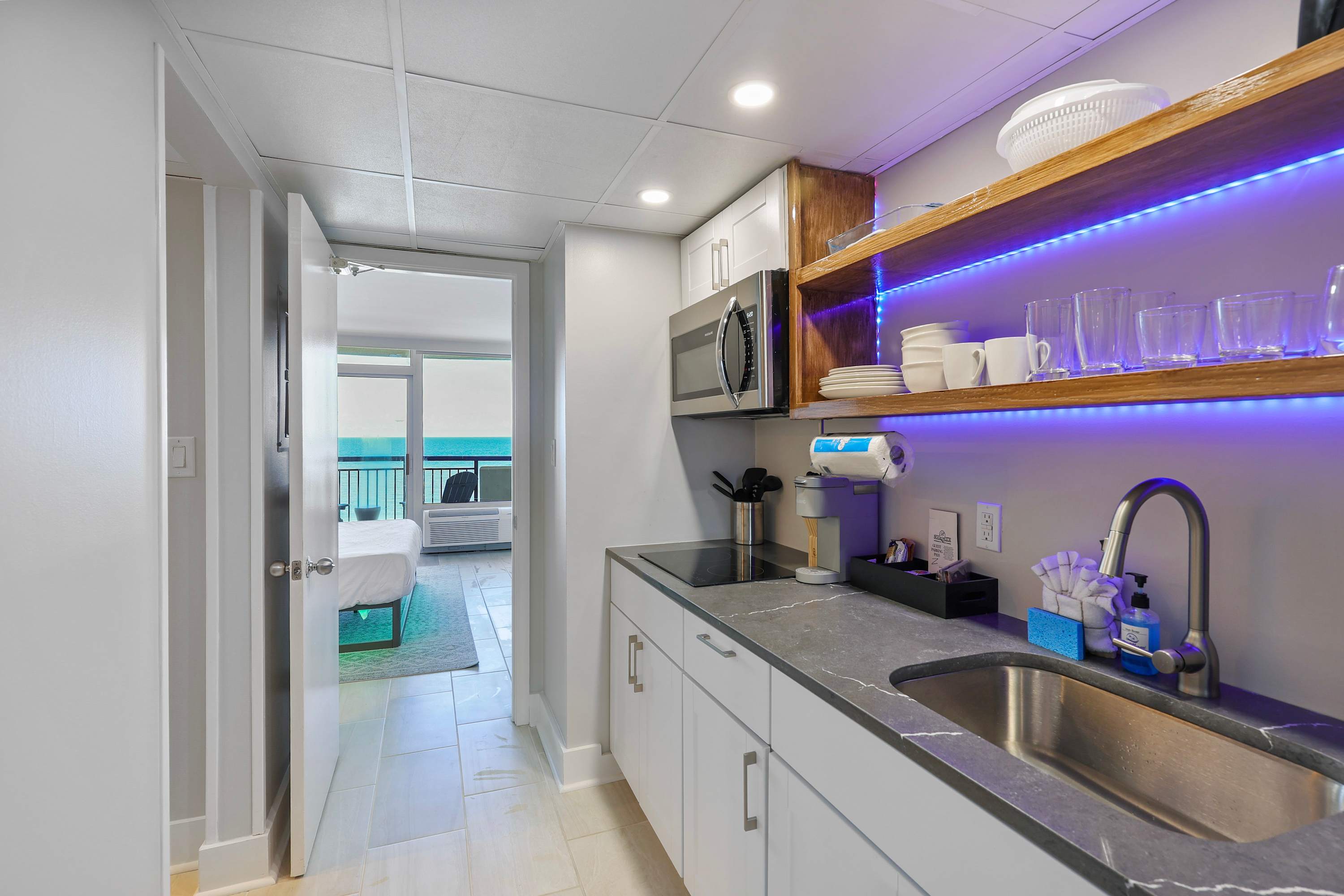 Wake up to ocean views and brew your favorite coffee in this sleek kitchenette—fully stocked and steps from the beach. The perfect blend of comfort, convenience, and coastal charm for your next seaside escape!