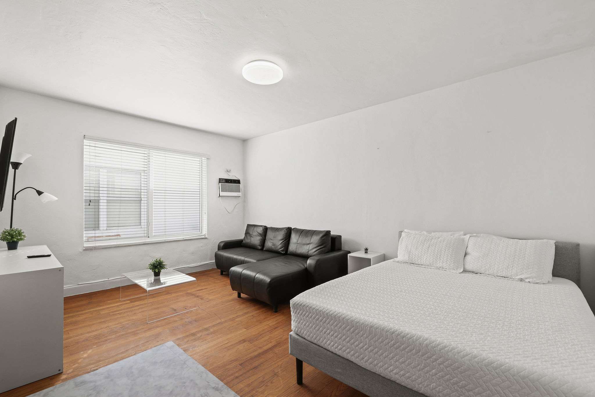 Cozy studio with natural light, comfy seating, and modern amenities for a relaxing stay.