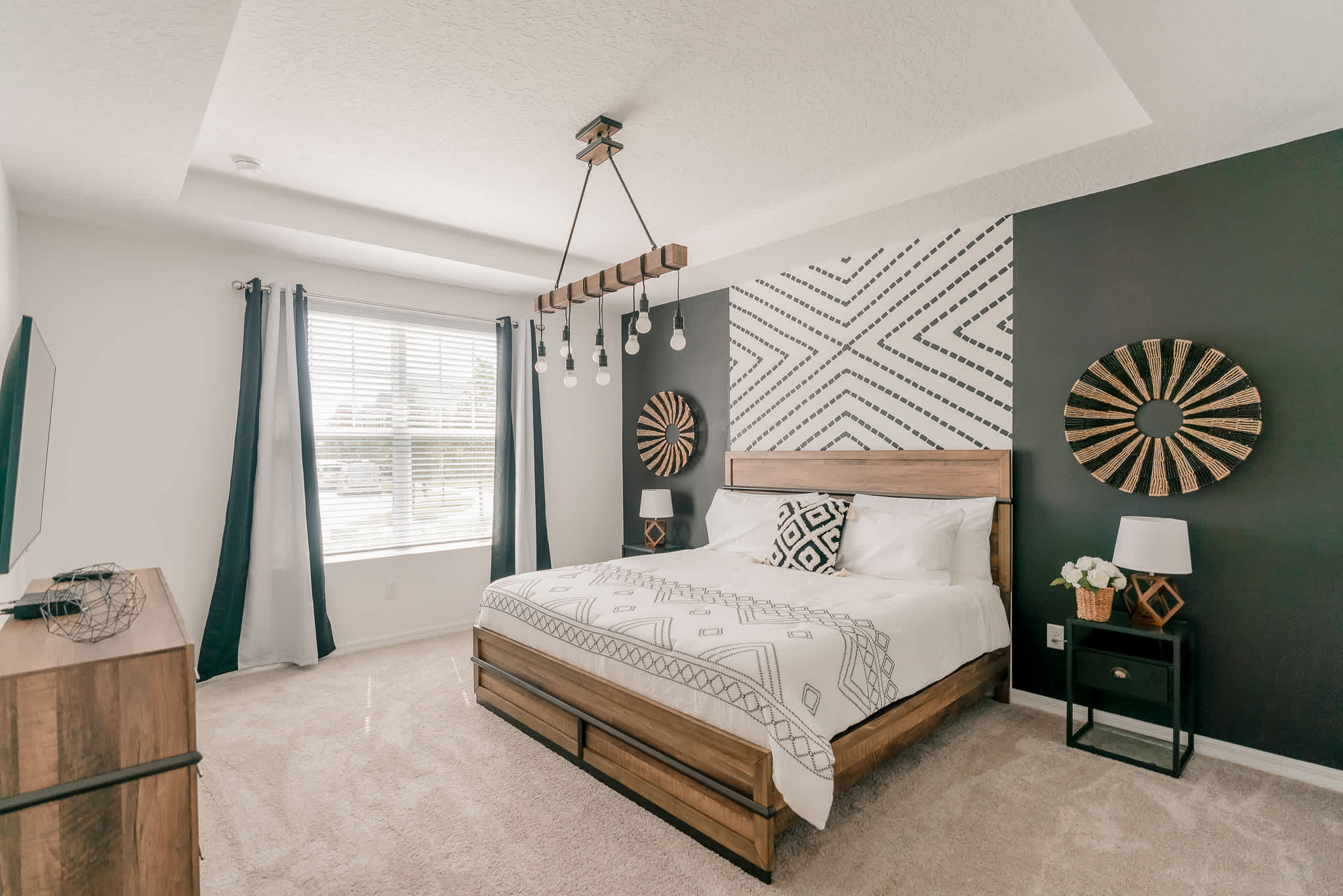Relax in this stylish bedroom featuring modern decor, cozy bedding, and ample natural light for a perfect retreat.