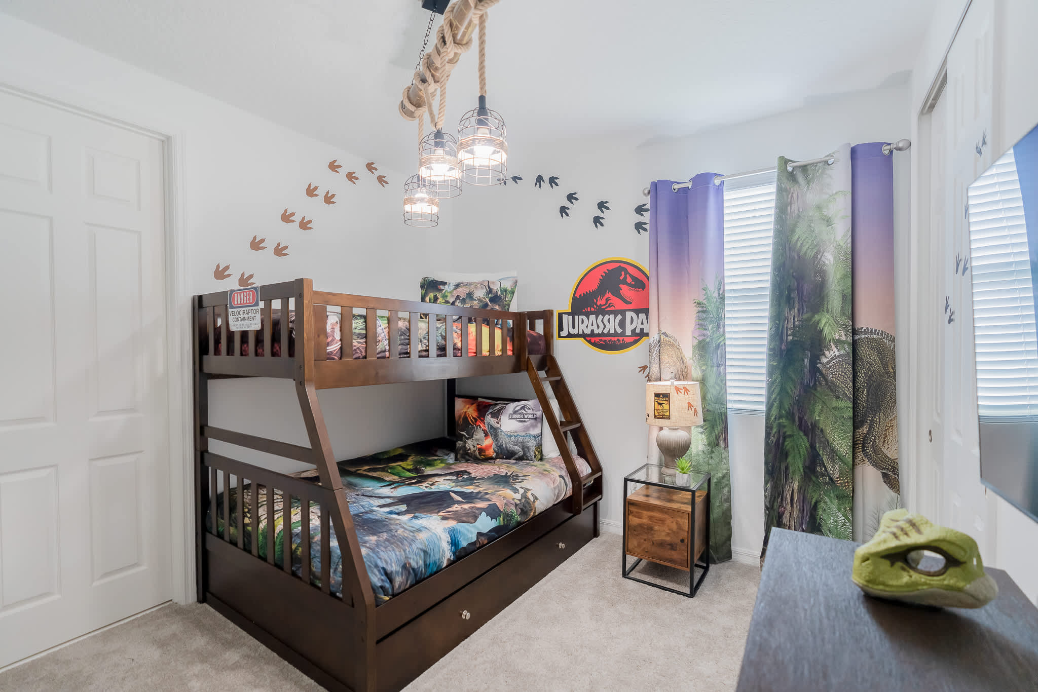 Immerse your kids in a Jurassic adventure with this themed bedroom, complete with dinosaur decor and cozy bunk beds.