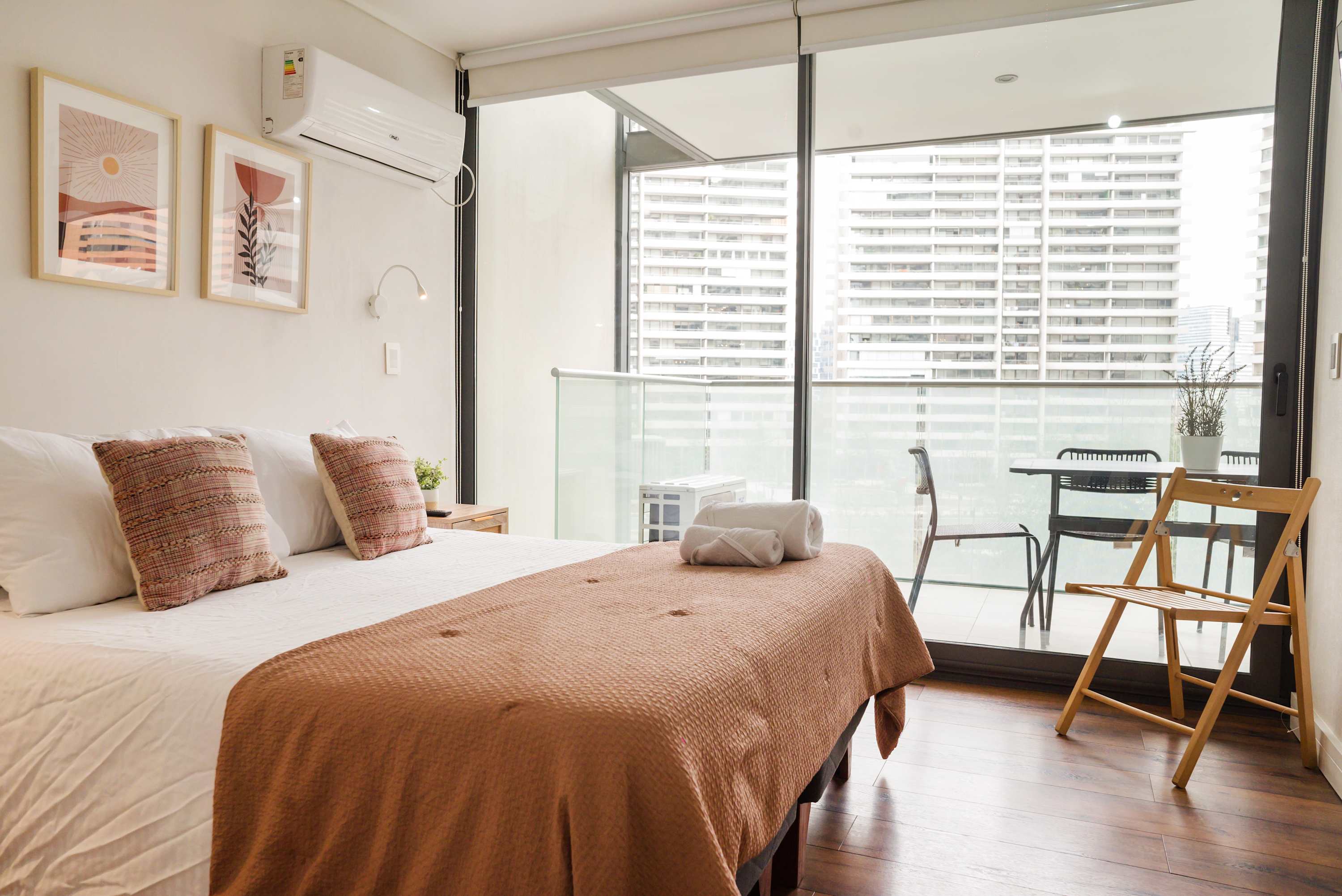 Relax in this cozy bedroom with a private balcony offering stunning city views. Perfect for unwinding after a day of exploring.
