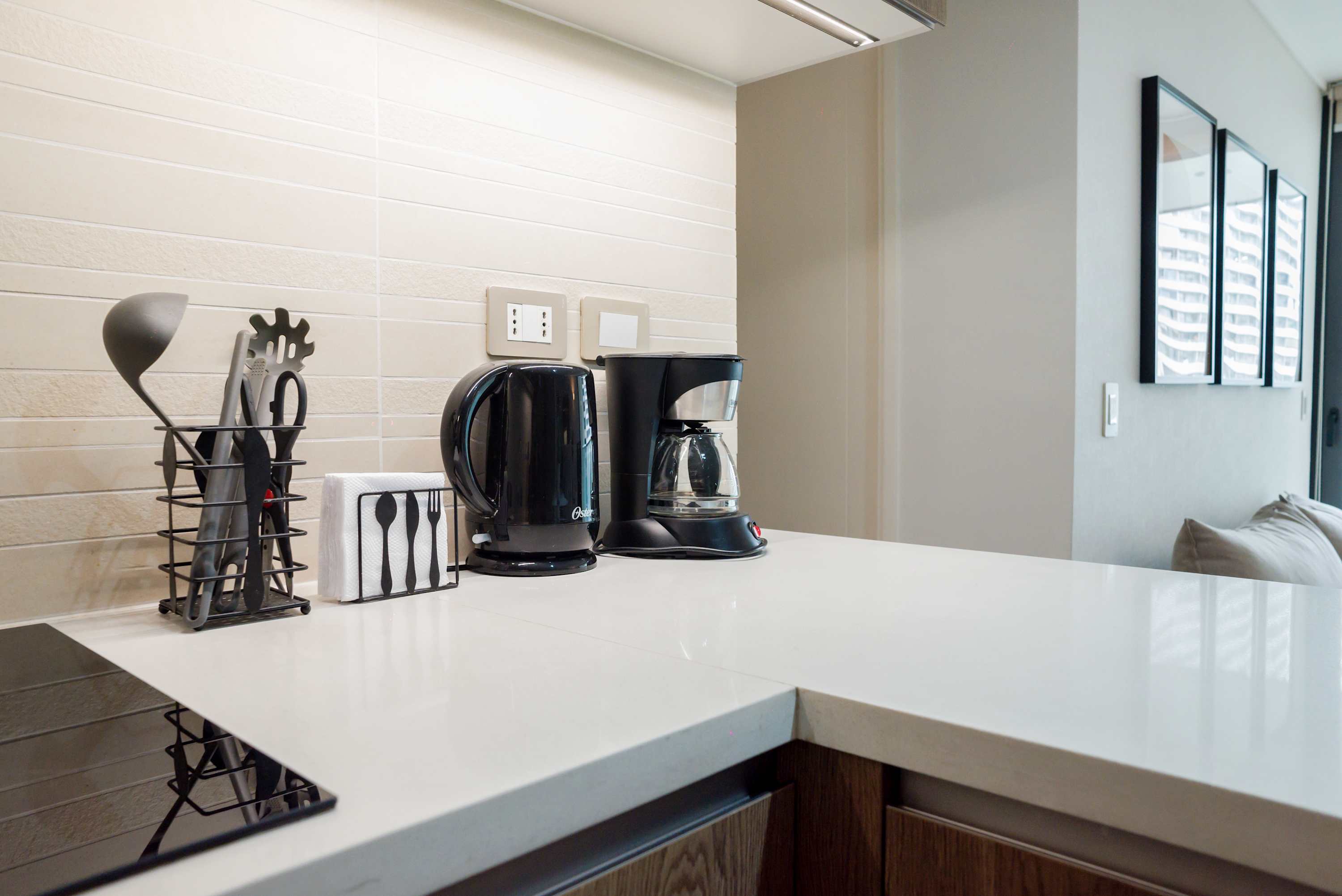 Enjoy a morning coffee in this sleek, modern kitchen with all the essentials for a comfortable stay.