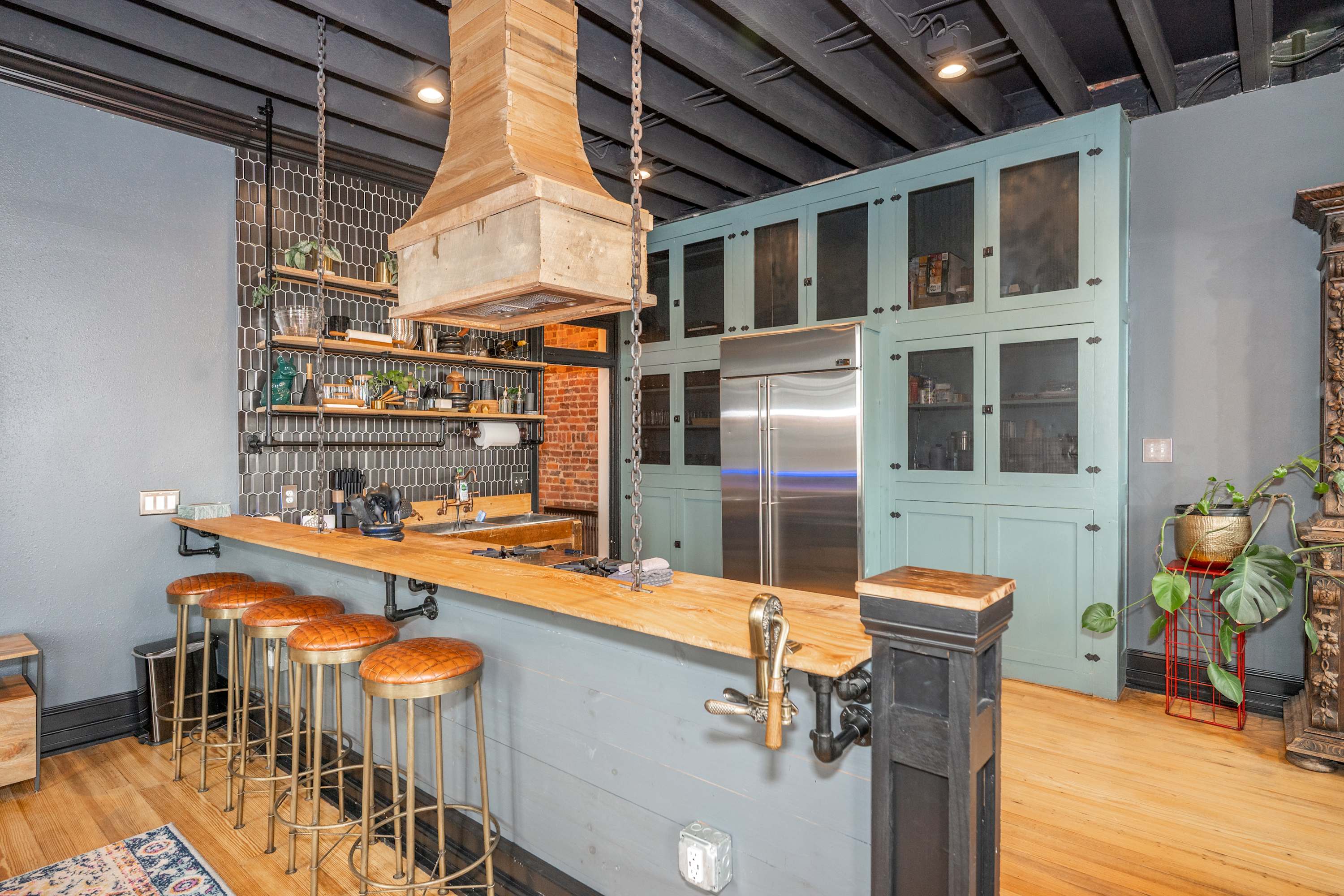The industrial chic kitchen offers ample space & all the comforts of home ​