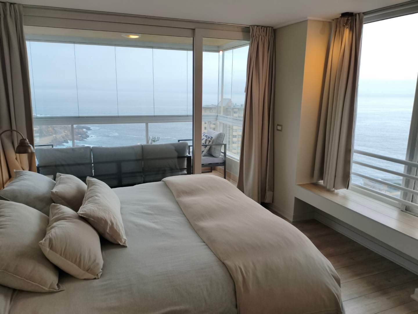 Wake up to breathtaking ocean views in this serene bedroom retreat, complete with a private balcony for your morning coffee.
