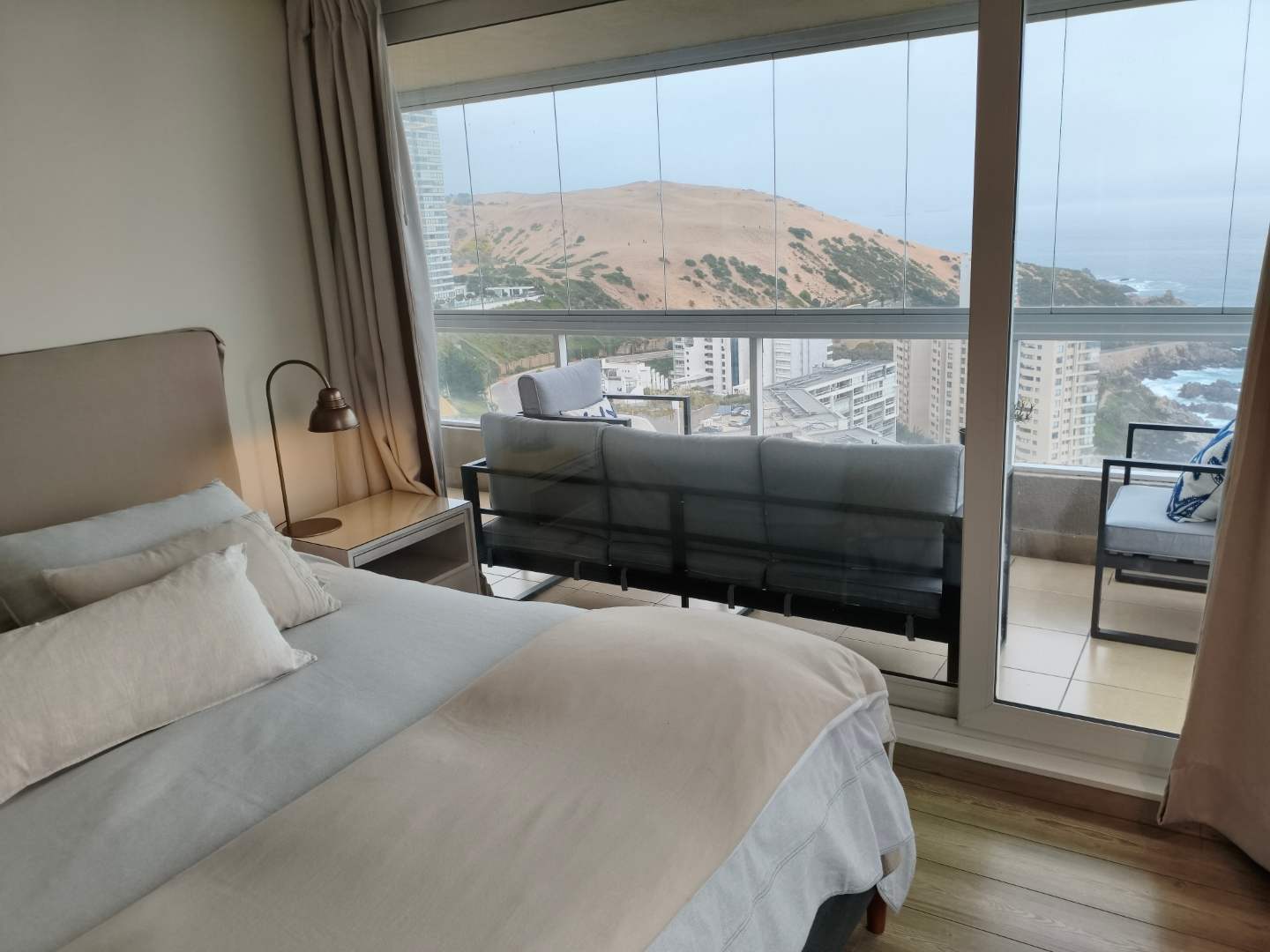 Relax in a cozy bedroom with breathtaking ocean views and a private balcony to soak in the scenery.