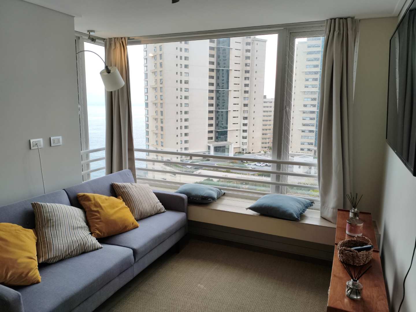 Relax in a cozy living room with stunning ocean views and modern decor, perfect for unwinding after a day of exploring.