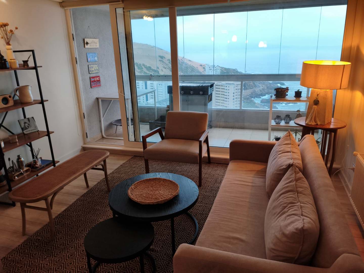 Relax in this cozy living room with breathtaking ocean views and stylish decor, perfect for unwinding after a day of exploring.