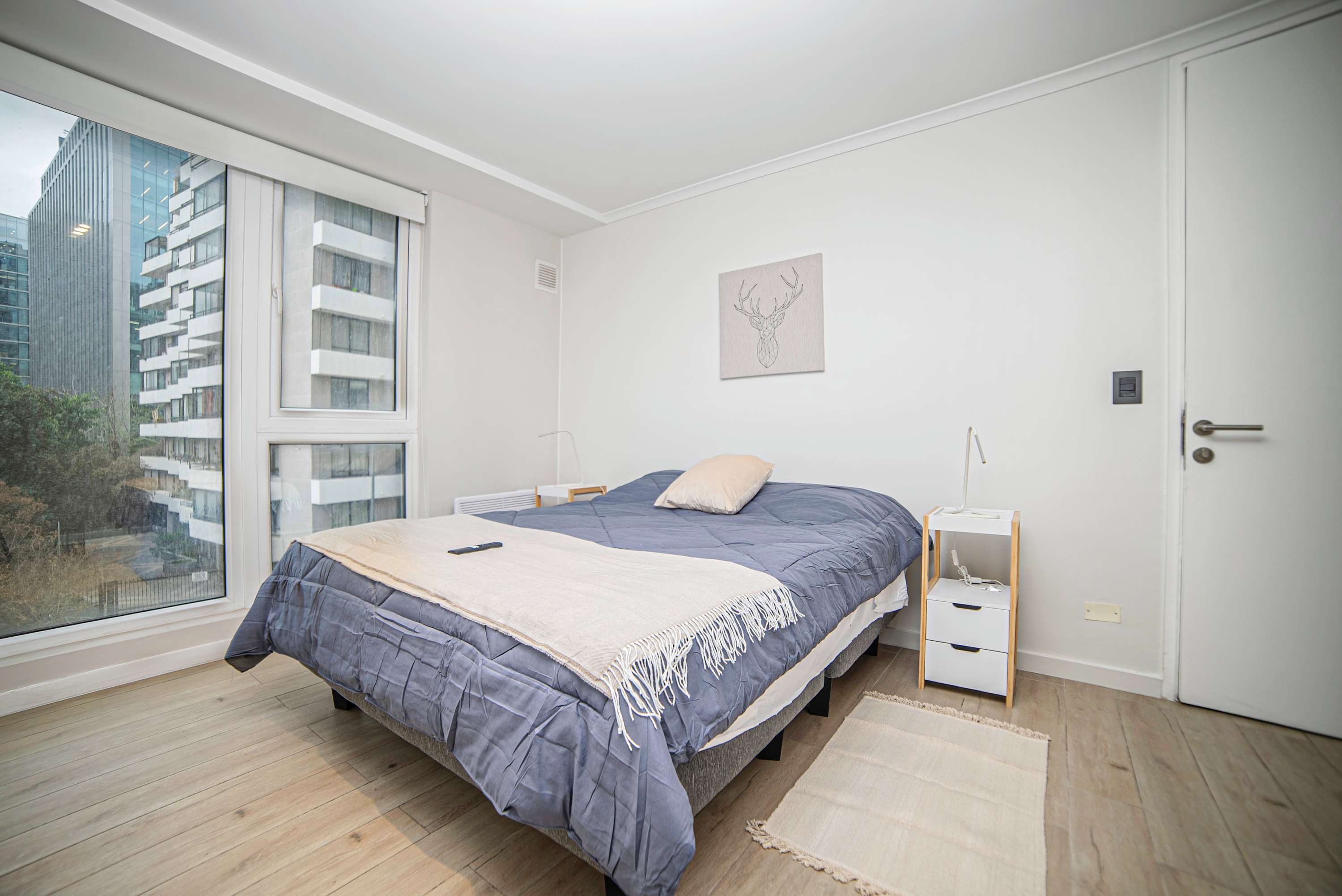 Cozy bedroom with stunning city views, perfect for a restful stay in the heart of Chile.