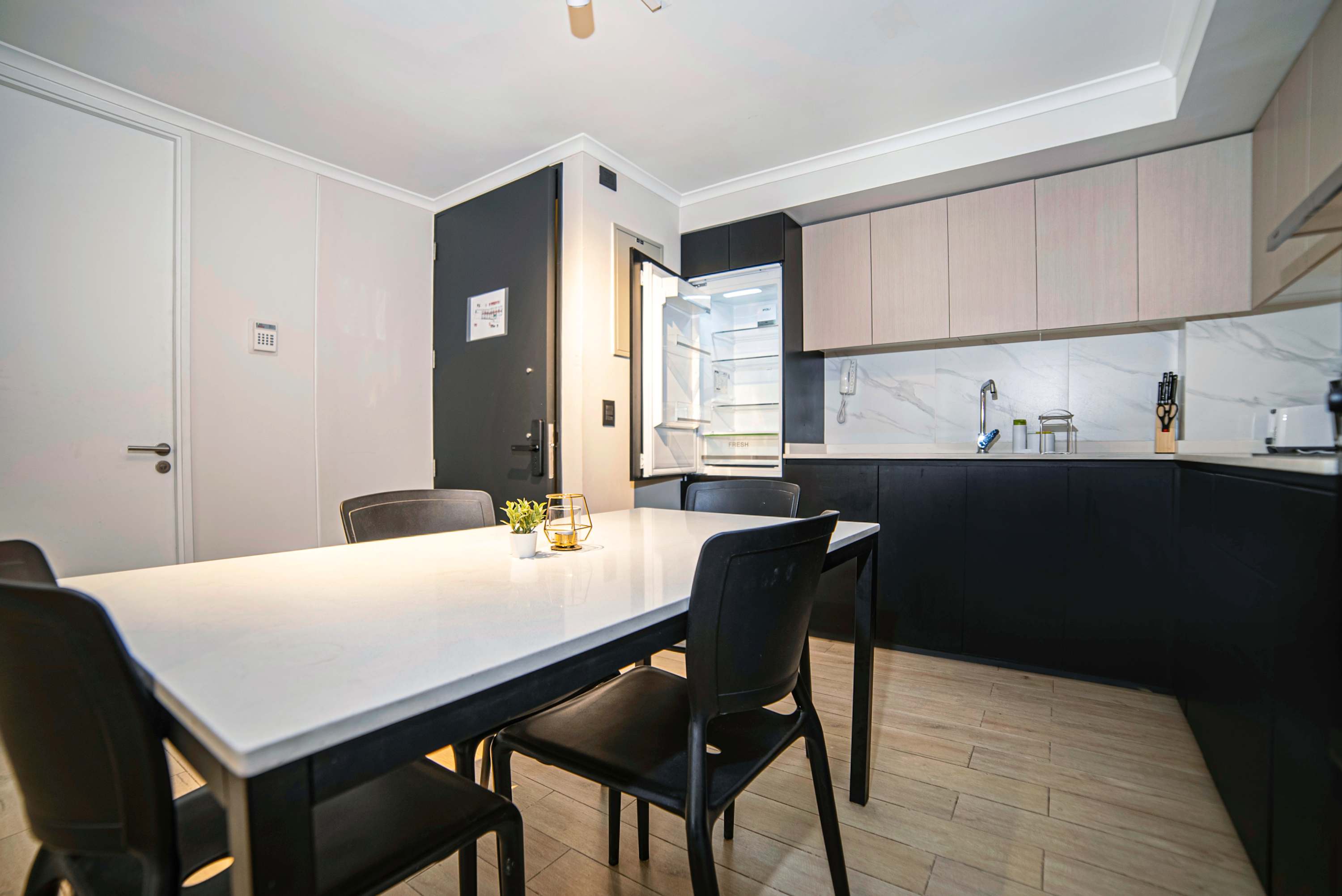 Modern kitchen with ample seating and sleek design, perfect for family meals or entertaining.