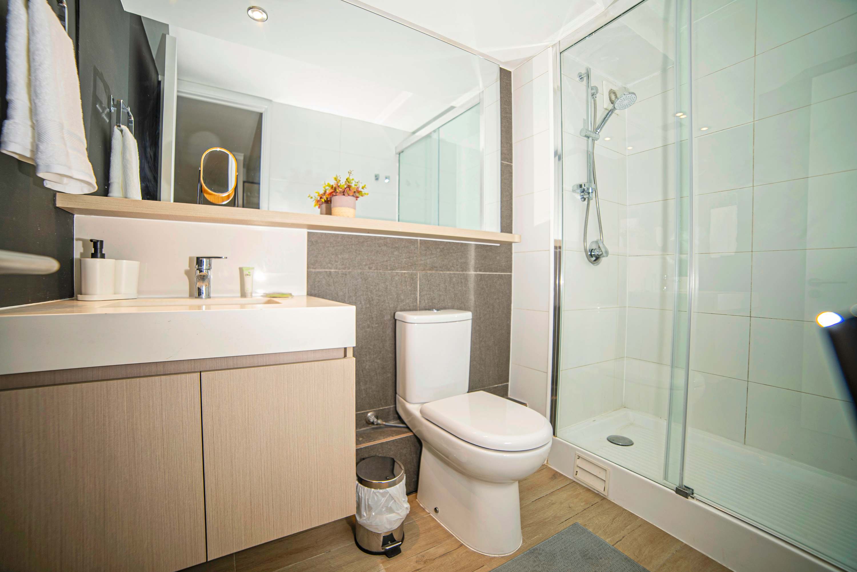 Experience modern comfort in this sleek bathroom with a spacious shower and stylish finishes.