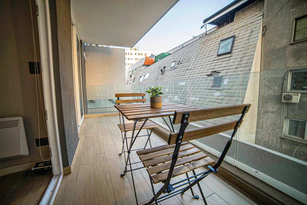 Enjoy your morning coffee on this charming private balcony with city views, perfect for a peaceful start to your day.