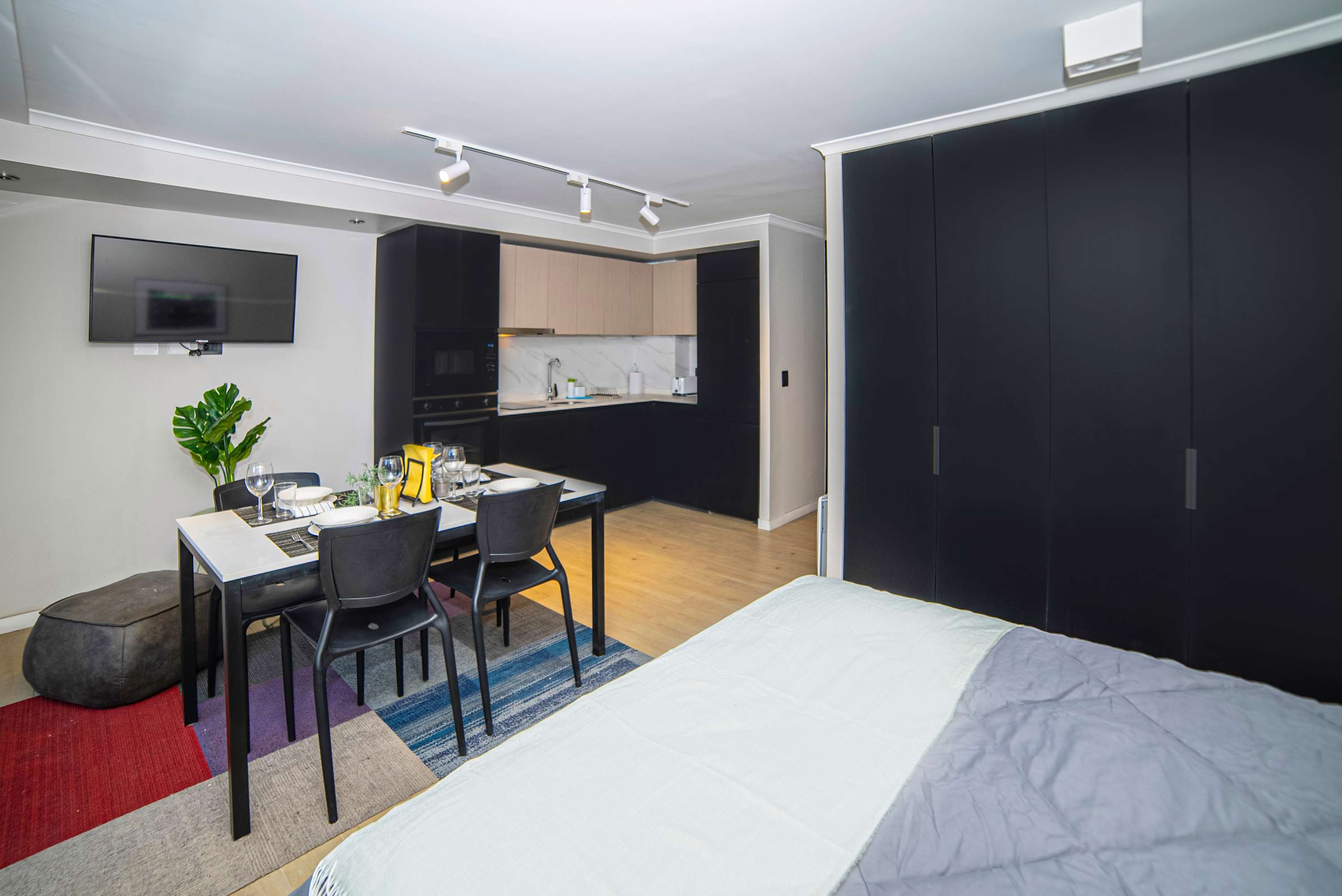 Modern studio apartment with sleek kitchen, cozy dining area, and stylish decor—perfect for a comfortable stay in the heart of Chile.