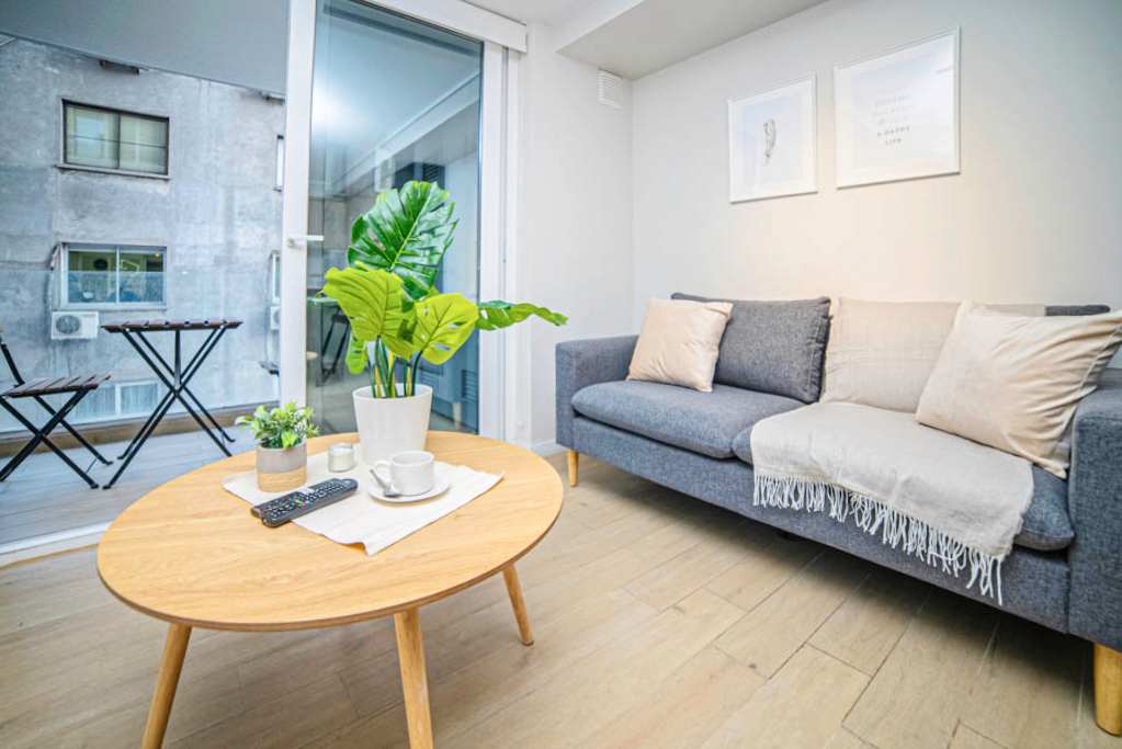 Relax in this cozy living space with a private balcony, perfect for unwinding after a day exploring the city.