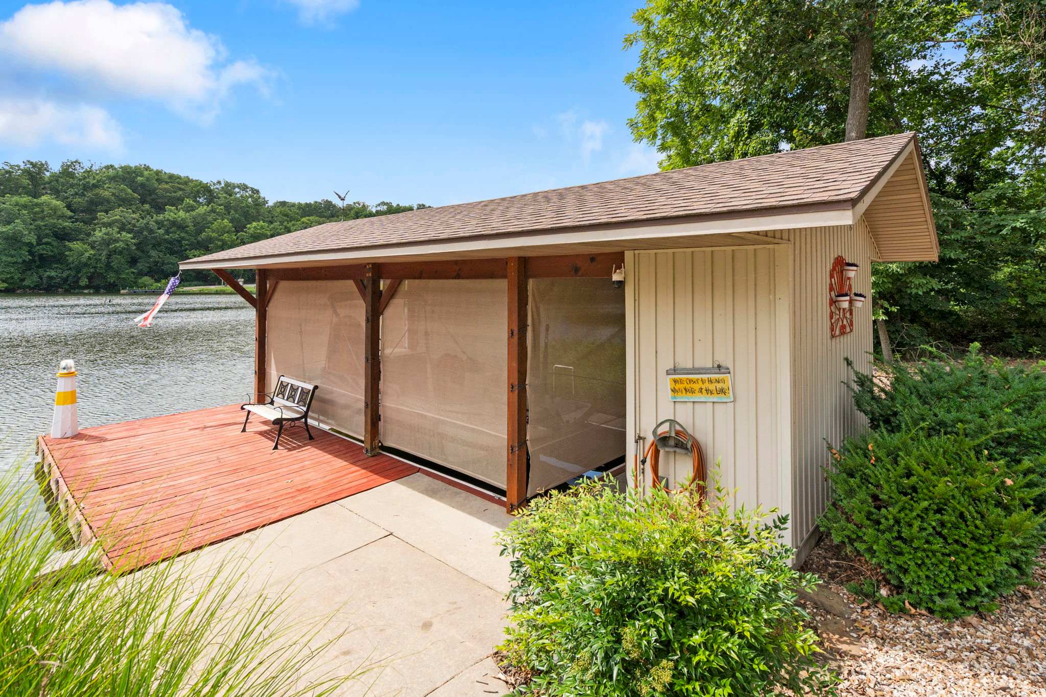 Boat dock and boat house with kayaks for use.
