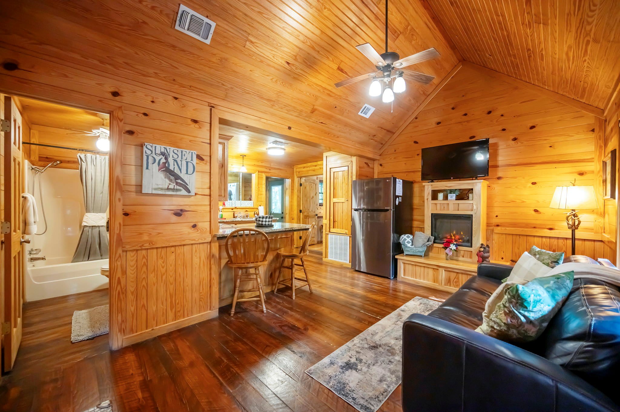 Step into the inviting living space with smart TV, fireplace, and queen sleeper sofa