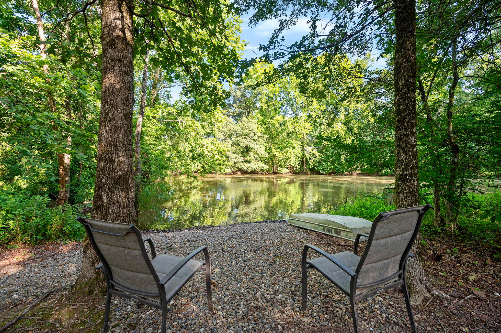 Peaceful backyard pond with seating—perfect for morning coffee or evening chats